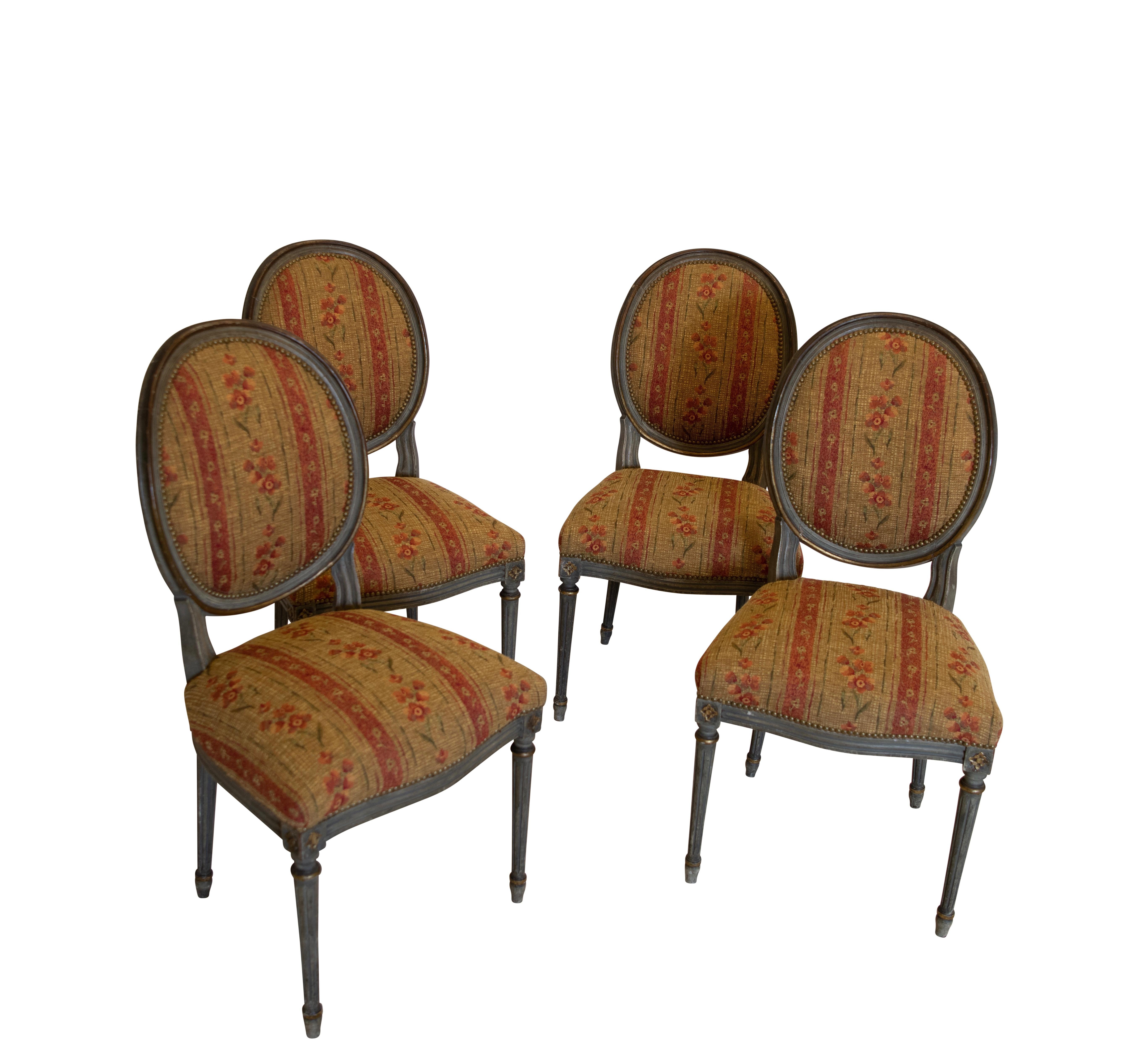 A set of four Louis XVI style upholstered side chairs. Having original paint and upholstered in vintage fabric in good condition. France, late 19th-early 20th century.