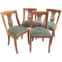 Set of Four French Neoclassical Fruitwood Lyre Back Chairs with Falcon Heads