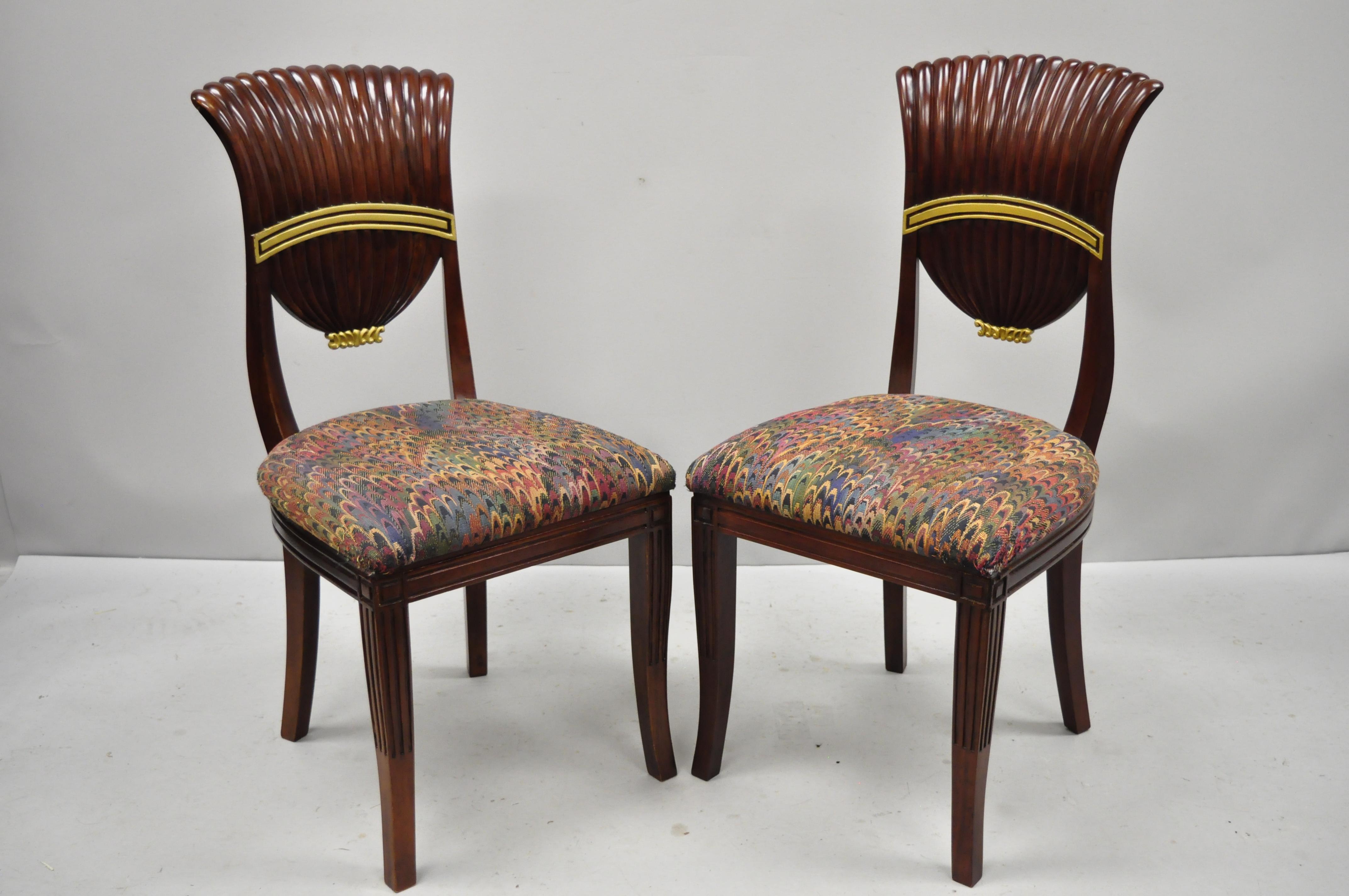 Set of four French neoclassical style shell fan back dining room chairs. Item features gold painted accents, shaped backs, (4) side chairs, solid wood construction, sleek sculptural form, circa late 20th century. Measurements: 38