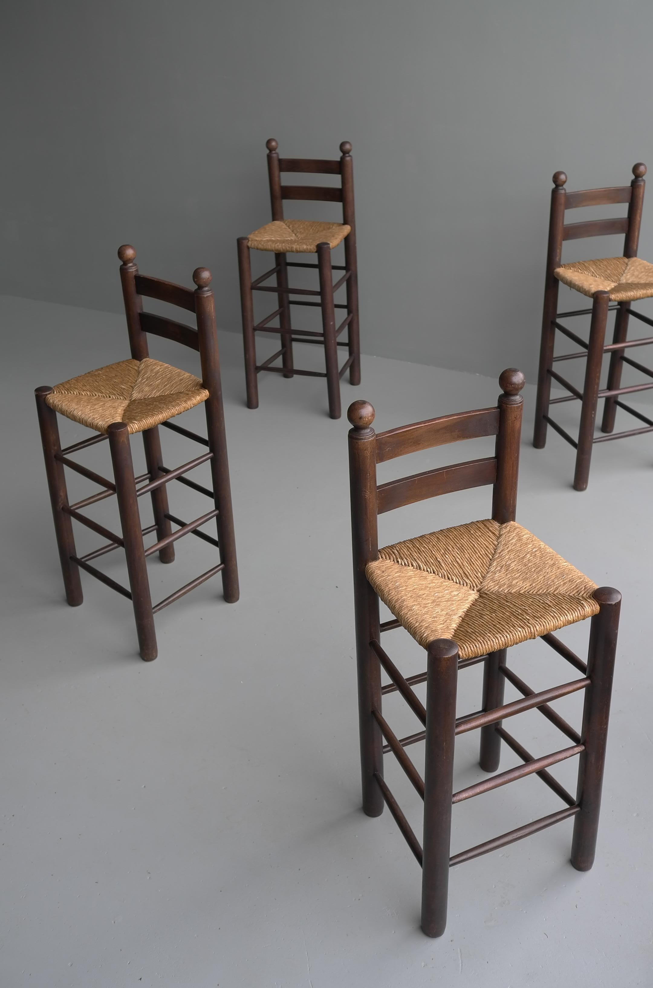 Set of four French oak barstools with rush seats in style of Charles Dudouyt.