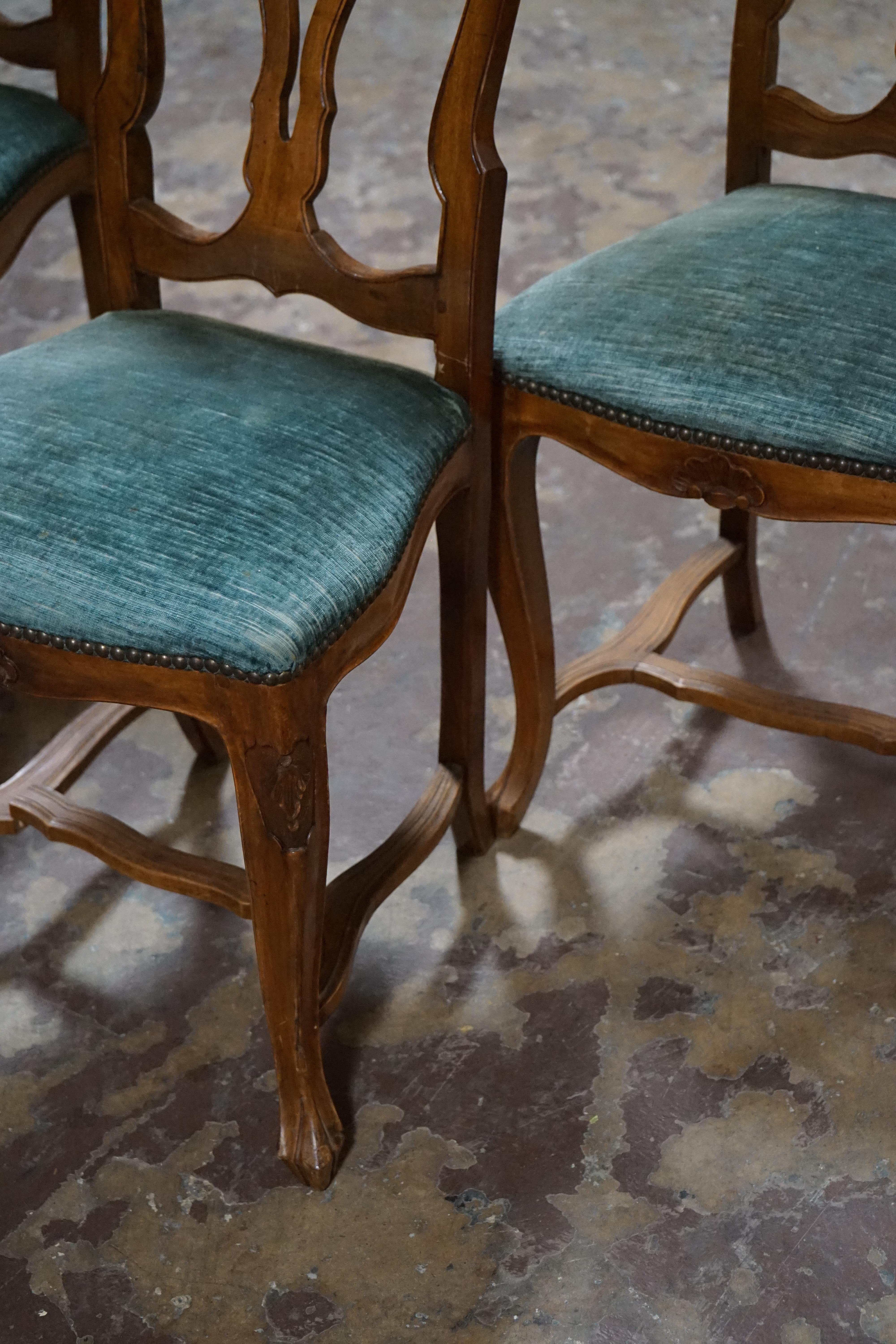 Set of four French side chairs featuring cabriole legs, bended back with cutout pattern.

Measurements: Overal 40.5'' H / Seat height 19'' / Width 18'' / Depth 16''.