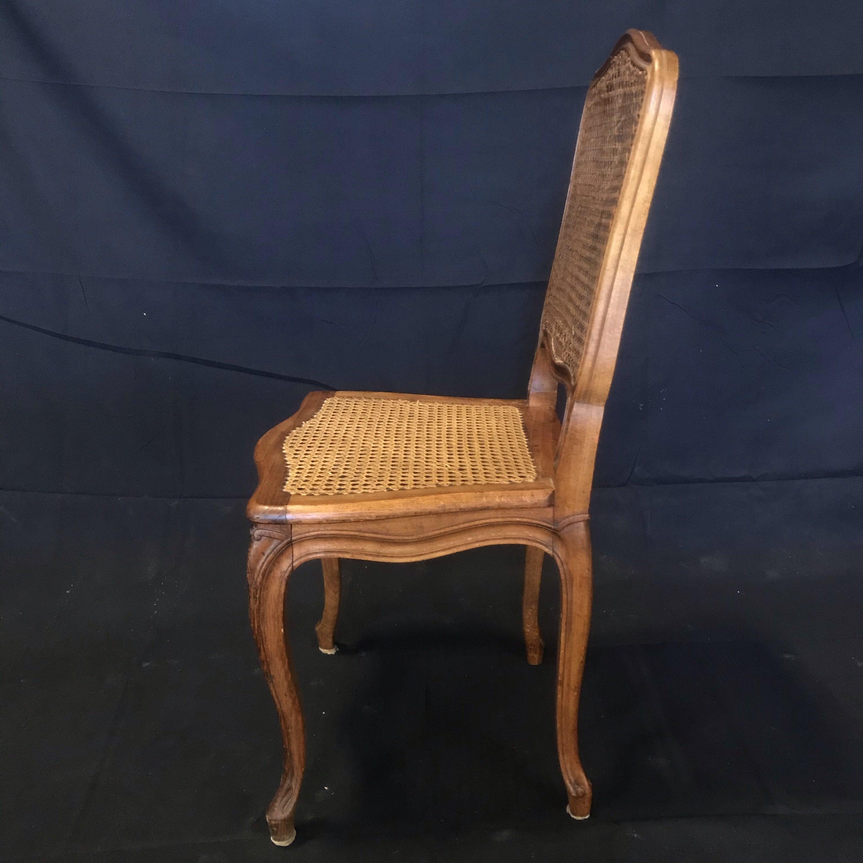 Set of Four French Walnut Carved Cane Dining Chairs In Fair Condition For Sale In Hopewell, NJ