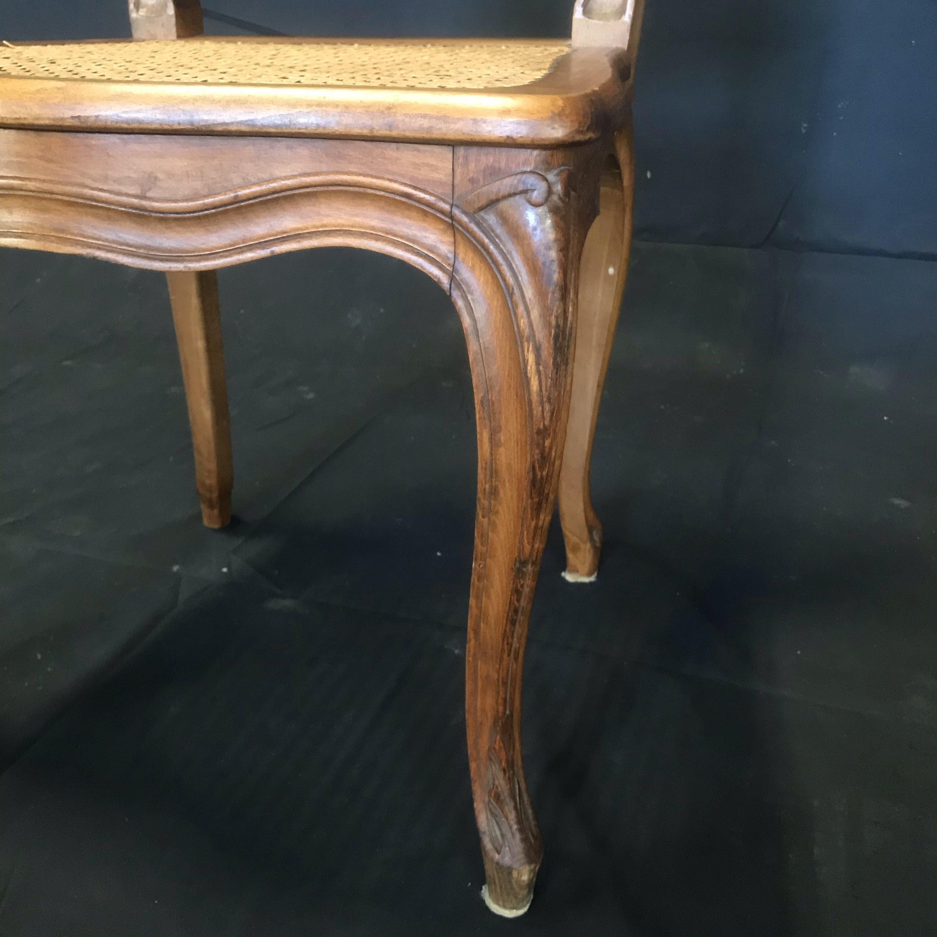 Early 20th Century Set of Four French Walnut Carved Cane Dining Chairs For Sale