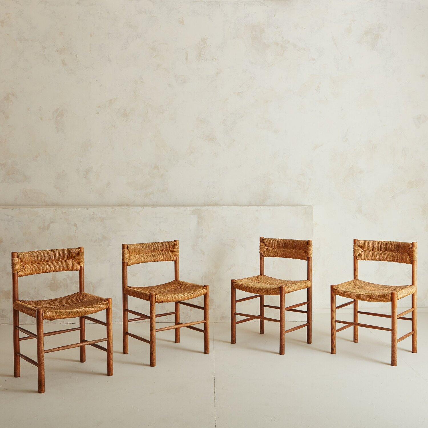 A set of four Rush and Wood ‘Dordogne’ chairs in the style of Robert Sentou. These chairs boast a harmony in materials, construction and design. These chairs are thoughtfully crafted of solid wood and rush. France, 1950s.