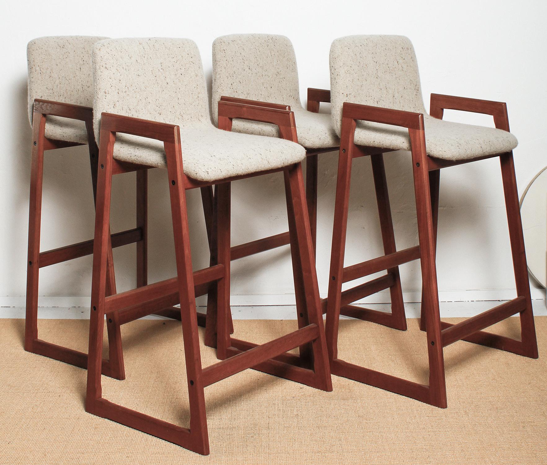 Set of four 1960s Danish teak bar stools, professionally re-finished and upholstered in a heavy brushed linen tweed with all new foam.