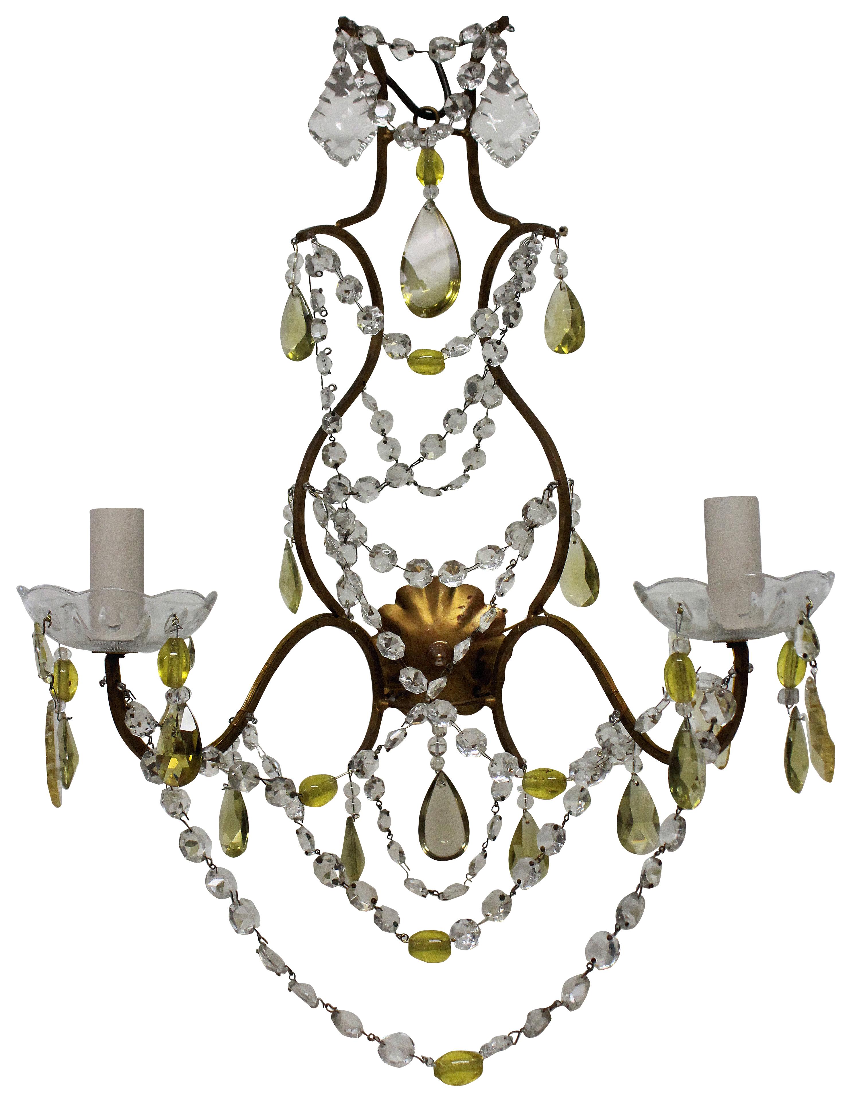 A set of four Genoese wall lights, with gold metal frames, hung throughout with pretty clear and lemon colored glass drops.