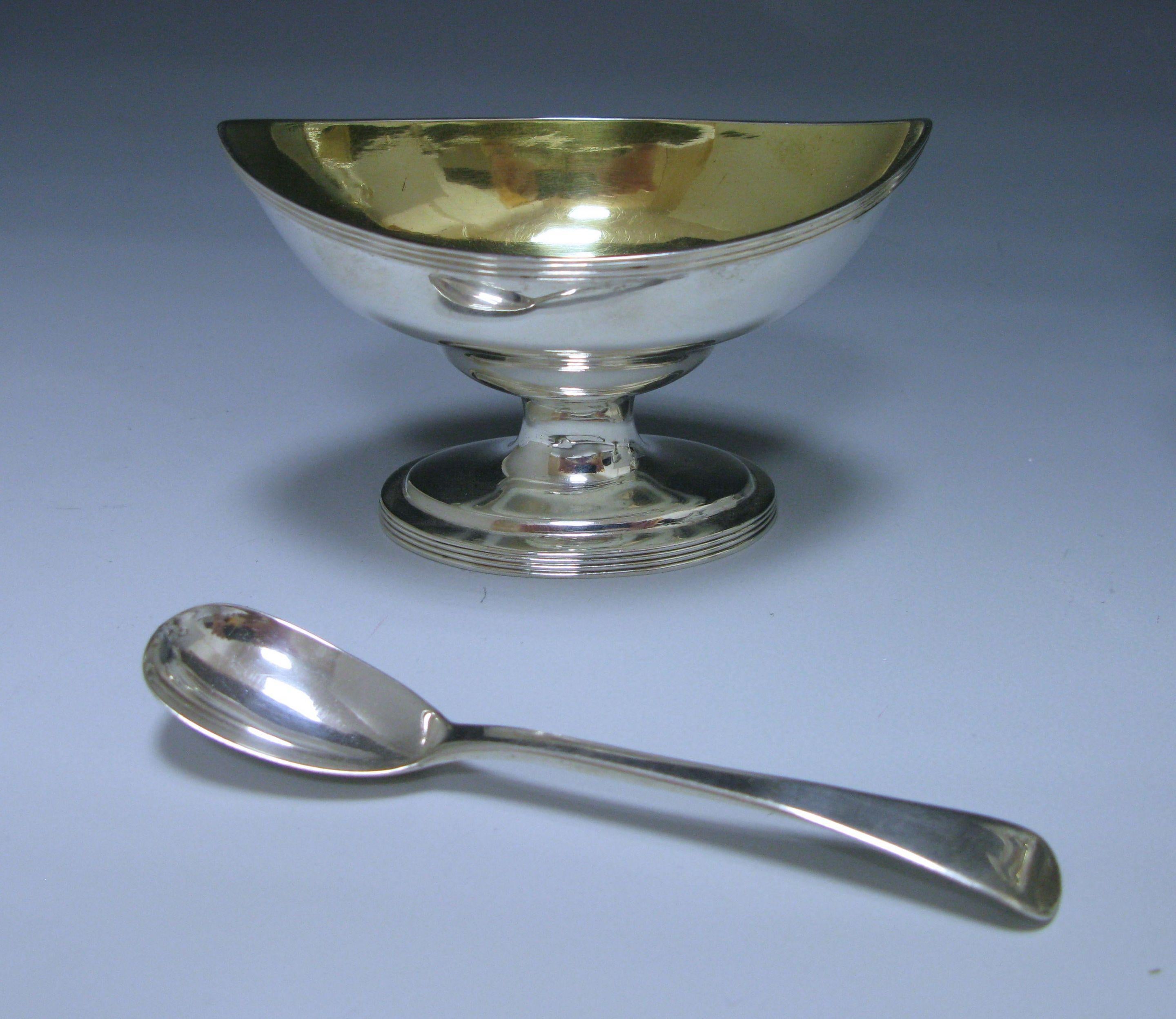 Set of four George III antique sterling silver salts of navette form with reeded borders all standing on oval pedestal bases on which reeded borders are repeated. The interior of each salt is gilded. They were made by Peter and Ann Bateman and over