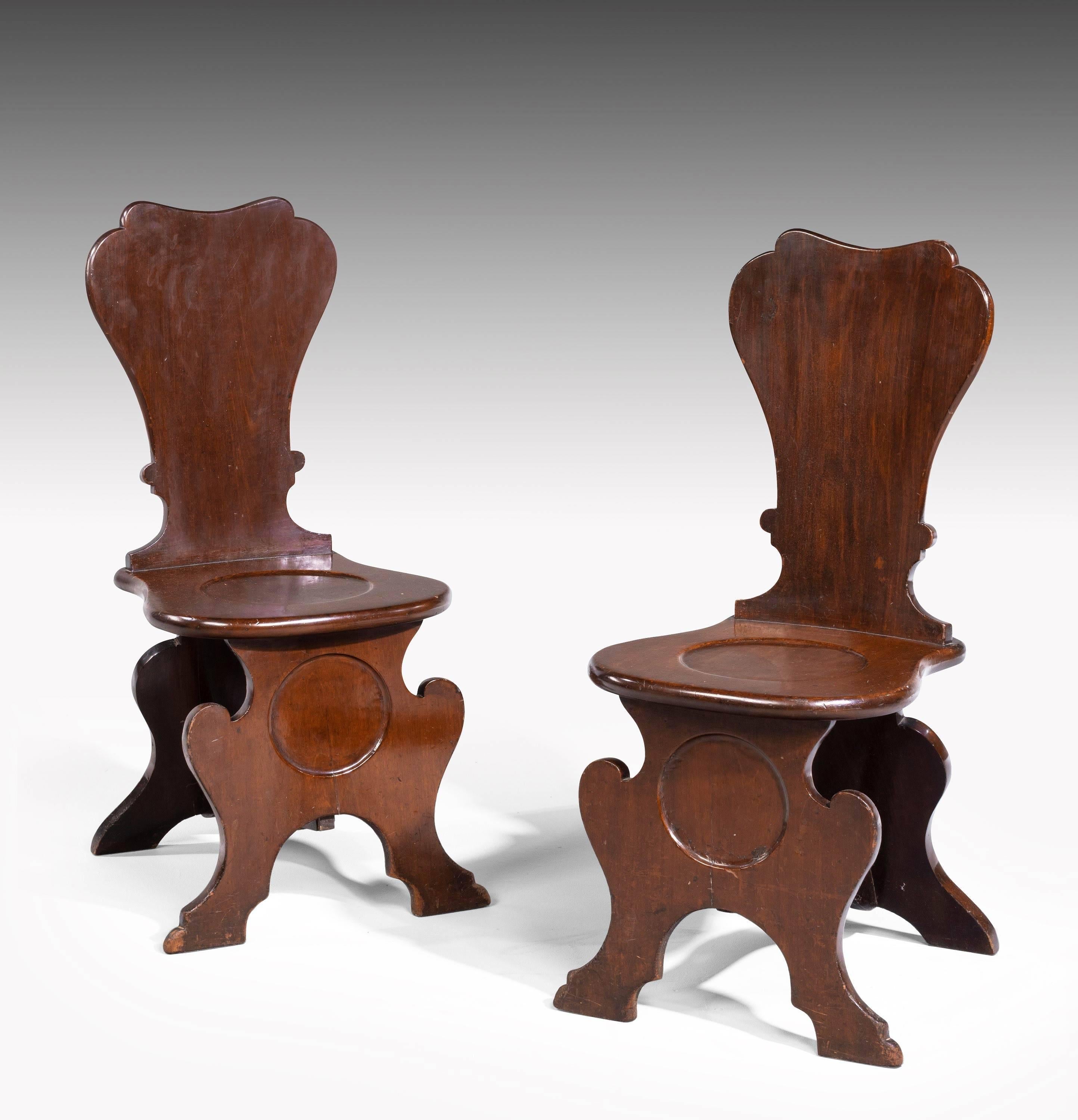 A good set of four George III period mahogany hall chairs. Well shaped and of substantial construction. In excellent overall condition. Possibly available in pairs. 

Seat height 17.75 inches (44cm).
T
 
