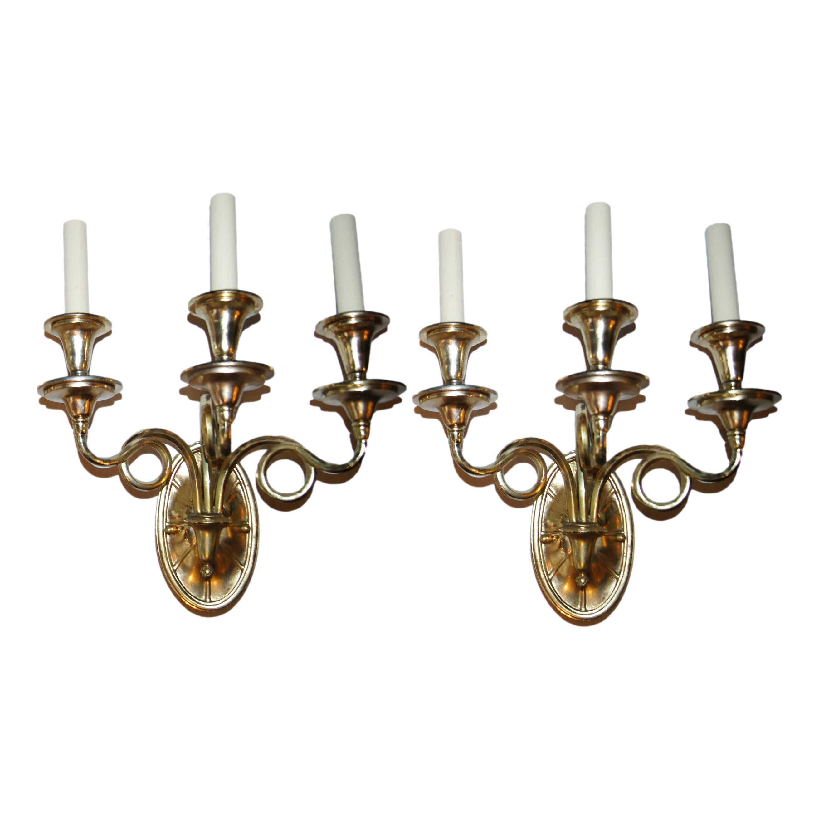 Set of four French circa 1940's gilt bronze gilt bronze three-arm sconces with oval backplate. Sold in pairs.

Measurements:
Height: 16