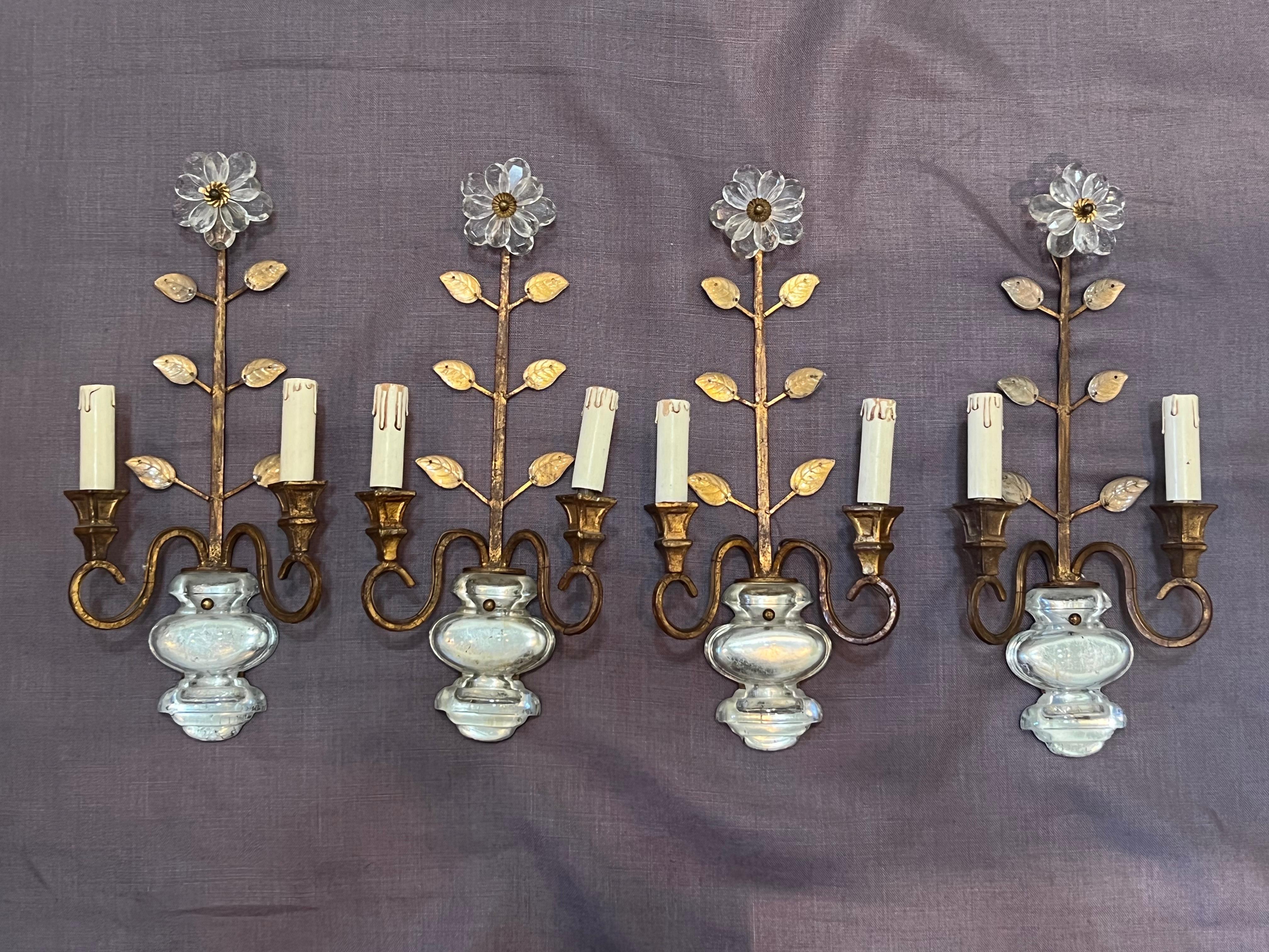 A set of four gilt iron and crystal sconces by Banci from the 1970s. These highly decorative sconces depicting flowers are a nice scale. They have not been rewired and will be delivered unwired.
