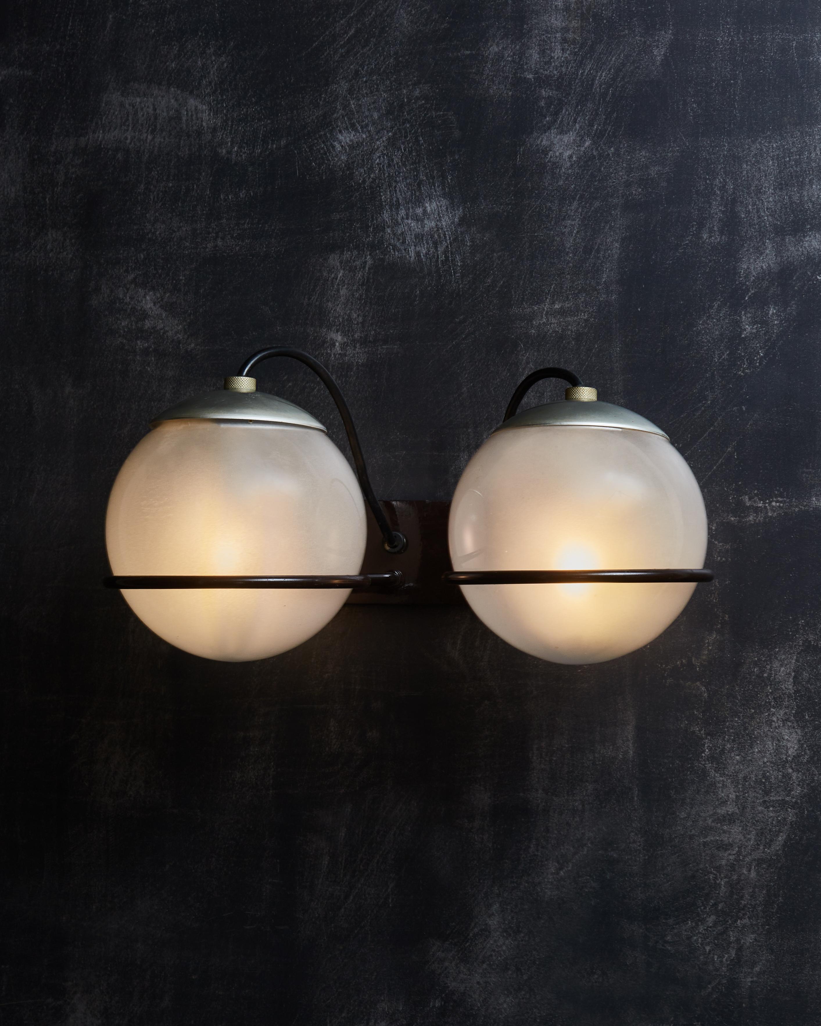 Set of four vintage model 237/2 wall sconces by Gino Sarfatti for Arteluce.
Two frosted glass globes resting on the black lacquered iron bar support rings.
 