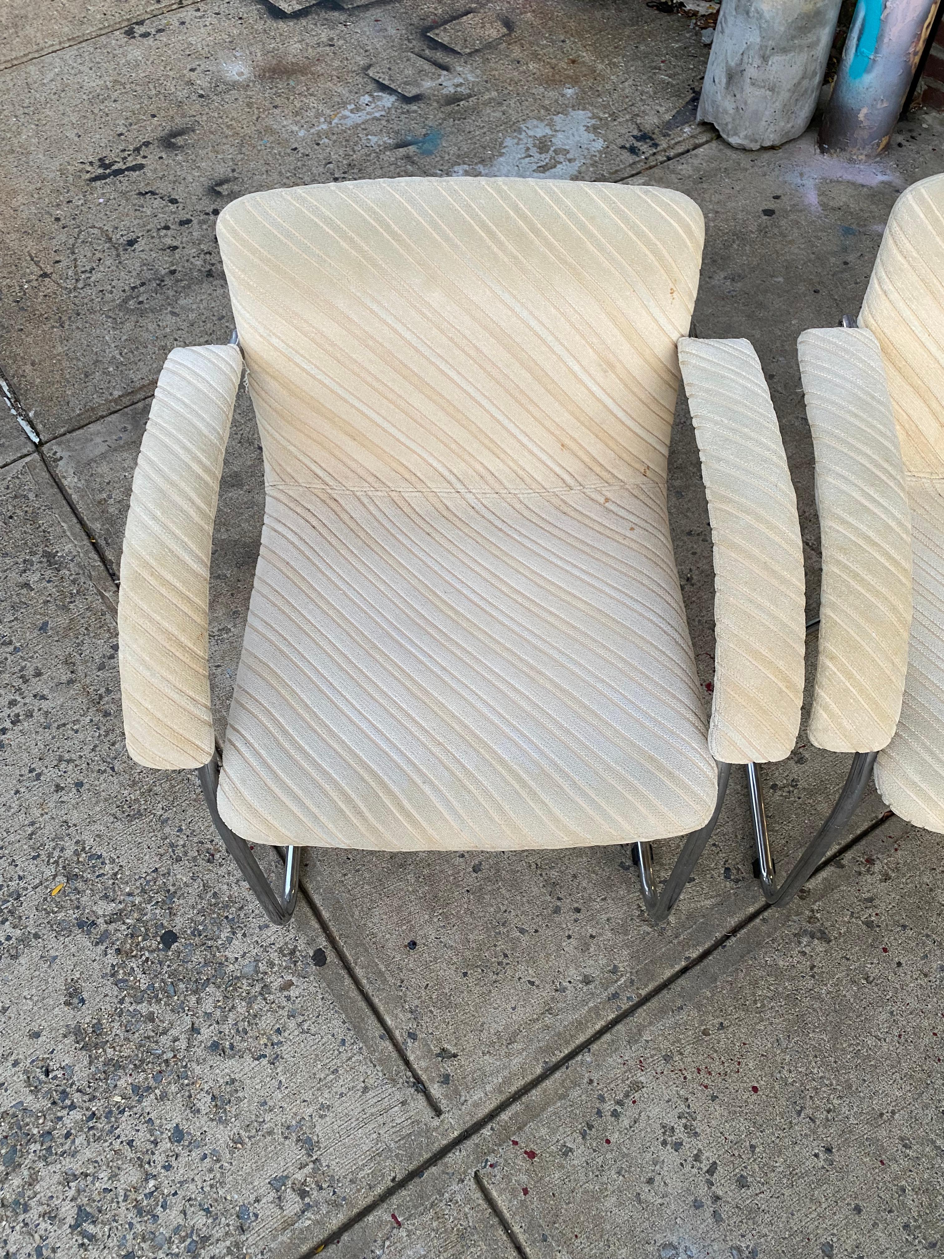 Beautiful lines on this set of four dining chairs by Gino Sarfatti for Saporiti Italia. Structurally sound with all parts intact. Could also be professionally steam cleaned and used as is. Great candidate for reupholstery in textile of your