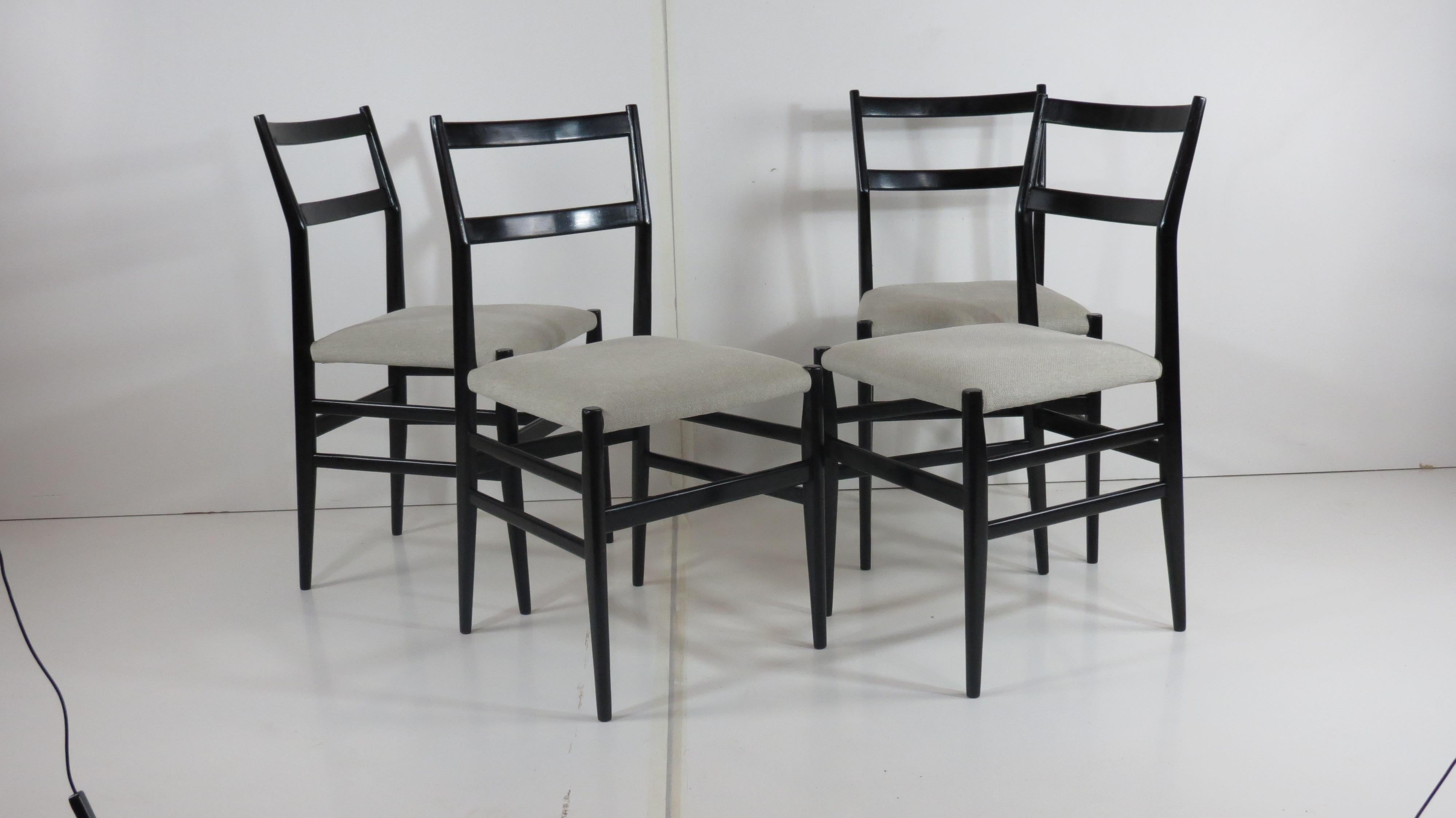 Four dining chairs designed by Gio Ponti and produced by F.gli Amedeo Cassina, 1952
provenience: Hotel in south Italy 
laquered in black 
newly reupholstered in grey cotton 
very good original condition 
ash and cotton 
Measures: height: 83