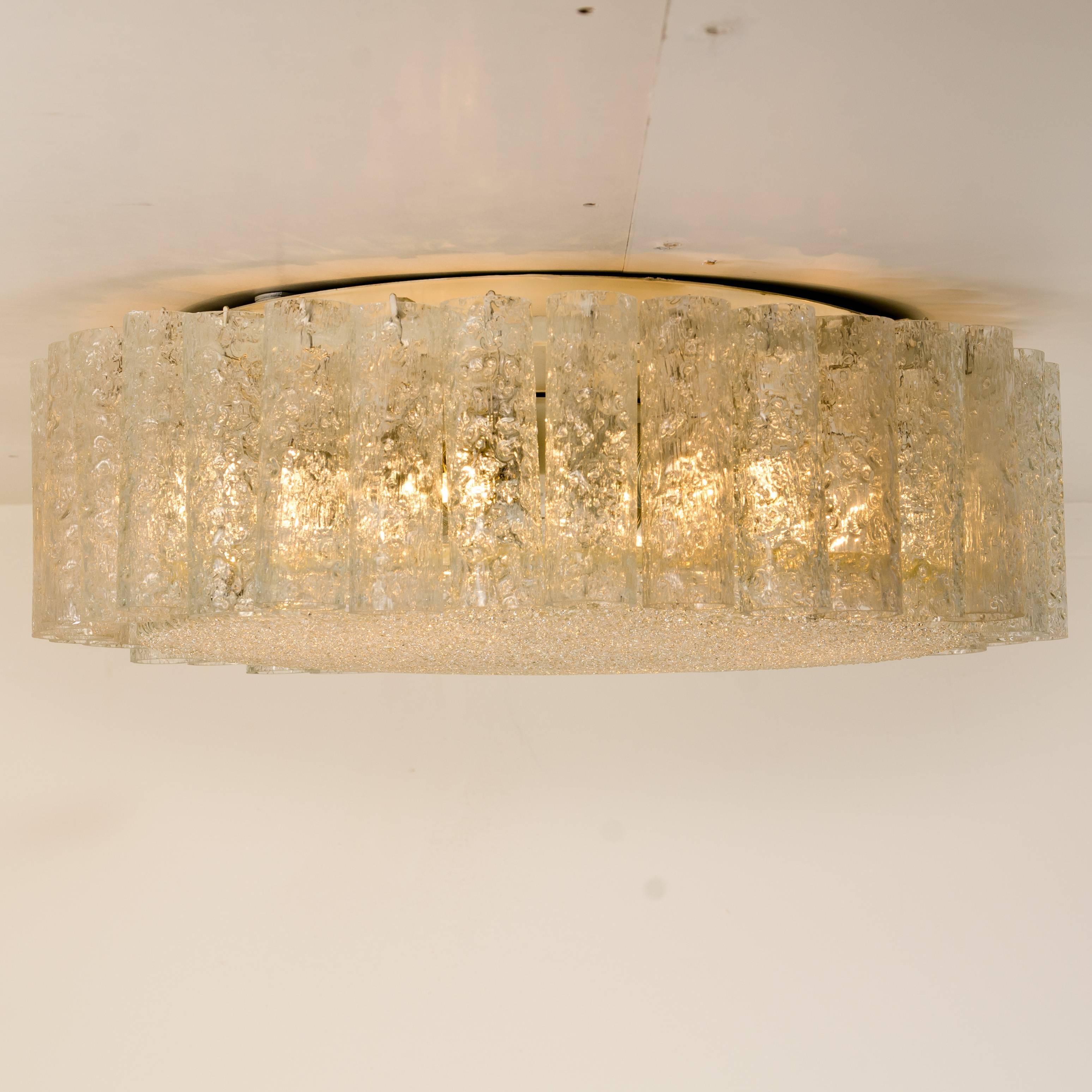 Wonderful set of four high end light fixtures. Two extra large flushmounts and two chandeliers by Doria (Germany) manufactured in the early 1960s-1970s.

Hanging cylinders of textured organic glass tubes. For a clean and elegant look. The glass
