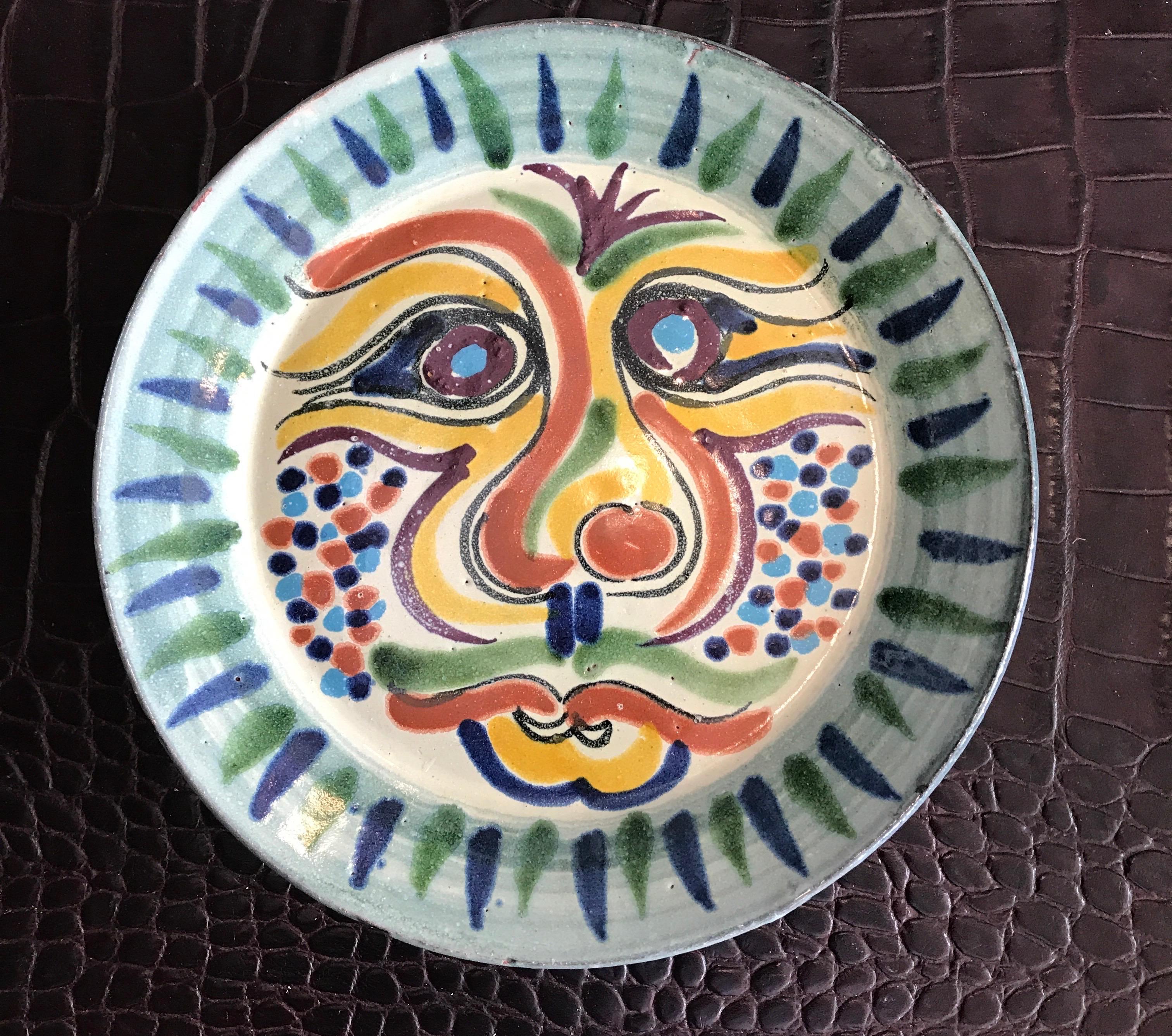 Set of four Picasso style decorative pottery face plates.