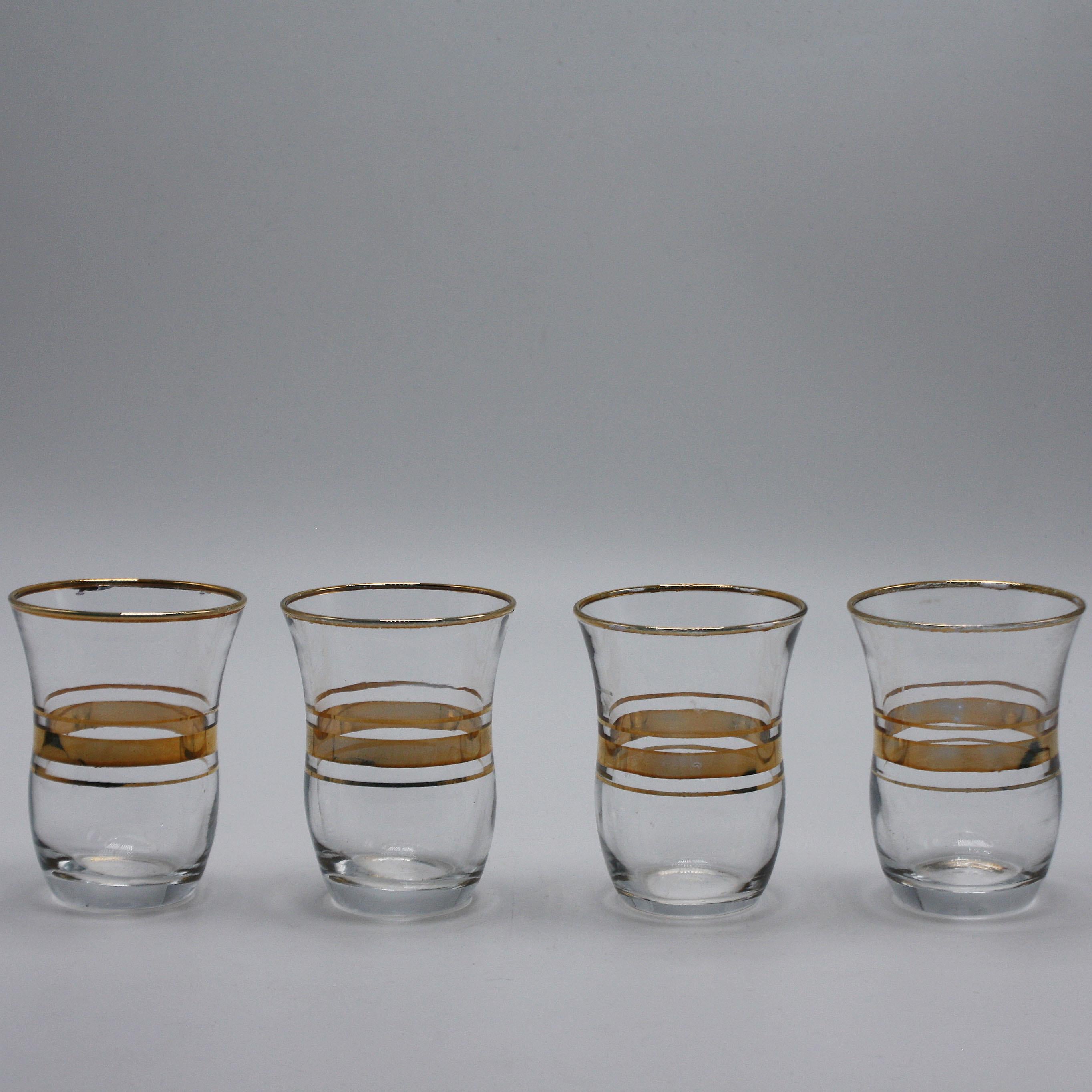 Set of four gold banded shot glasses, circa 1960
$195.