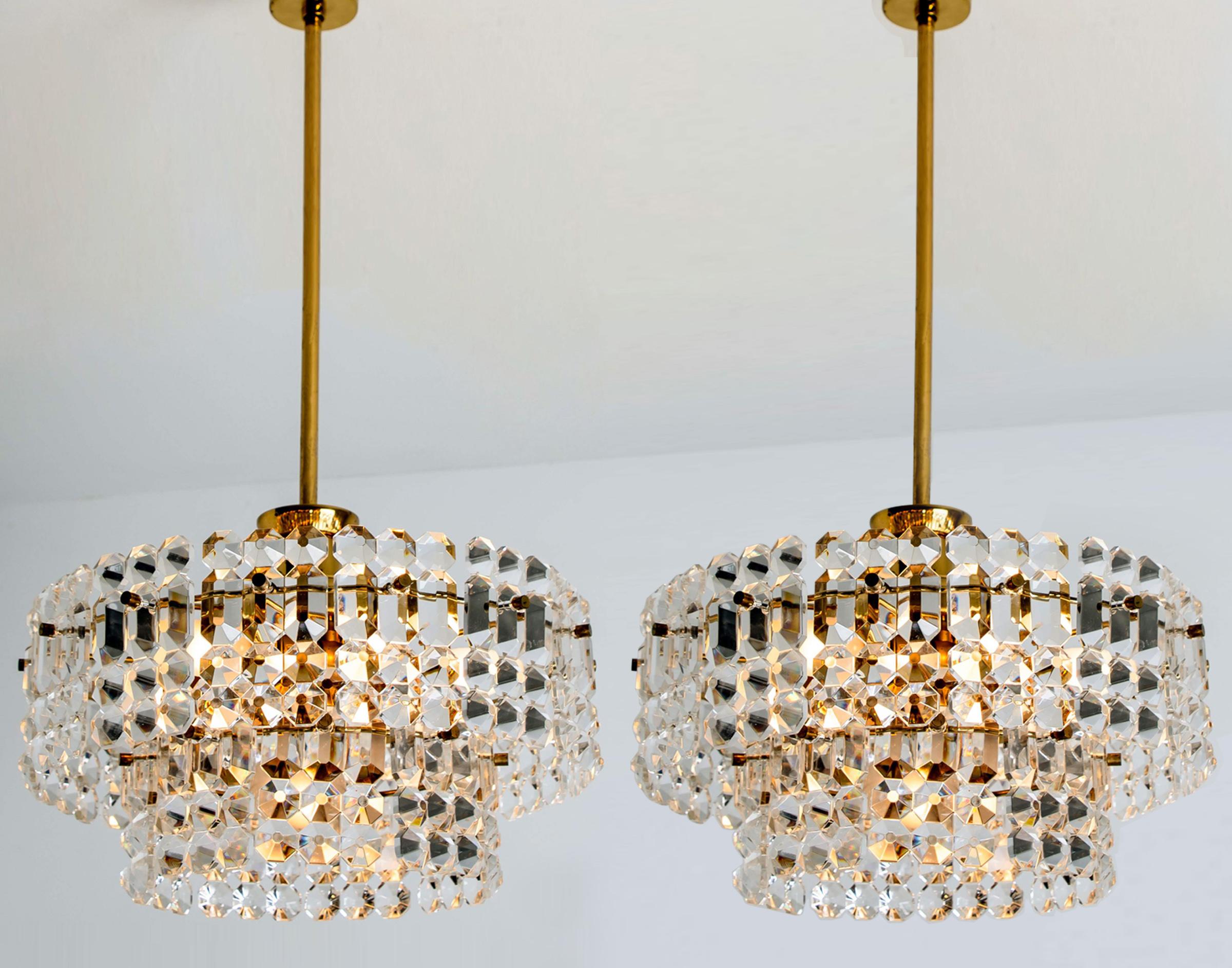 This modernist design chandeliers where designed by the Kinkeldey design team during the 1970s, and manufactured in Germany. A handmade and high quality piece. A set of four is rare to find. Two chandeliers and 2 wall lights.

The small crystals