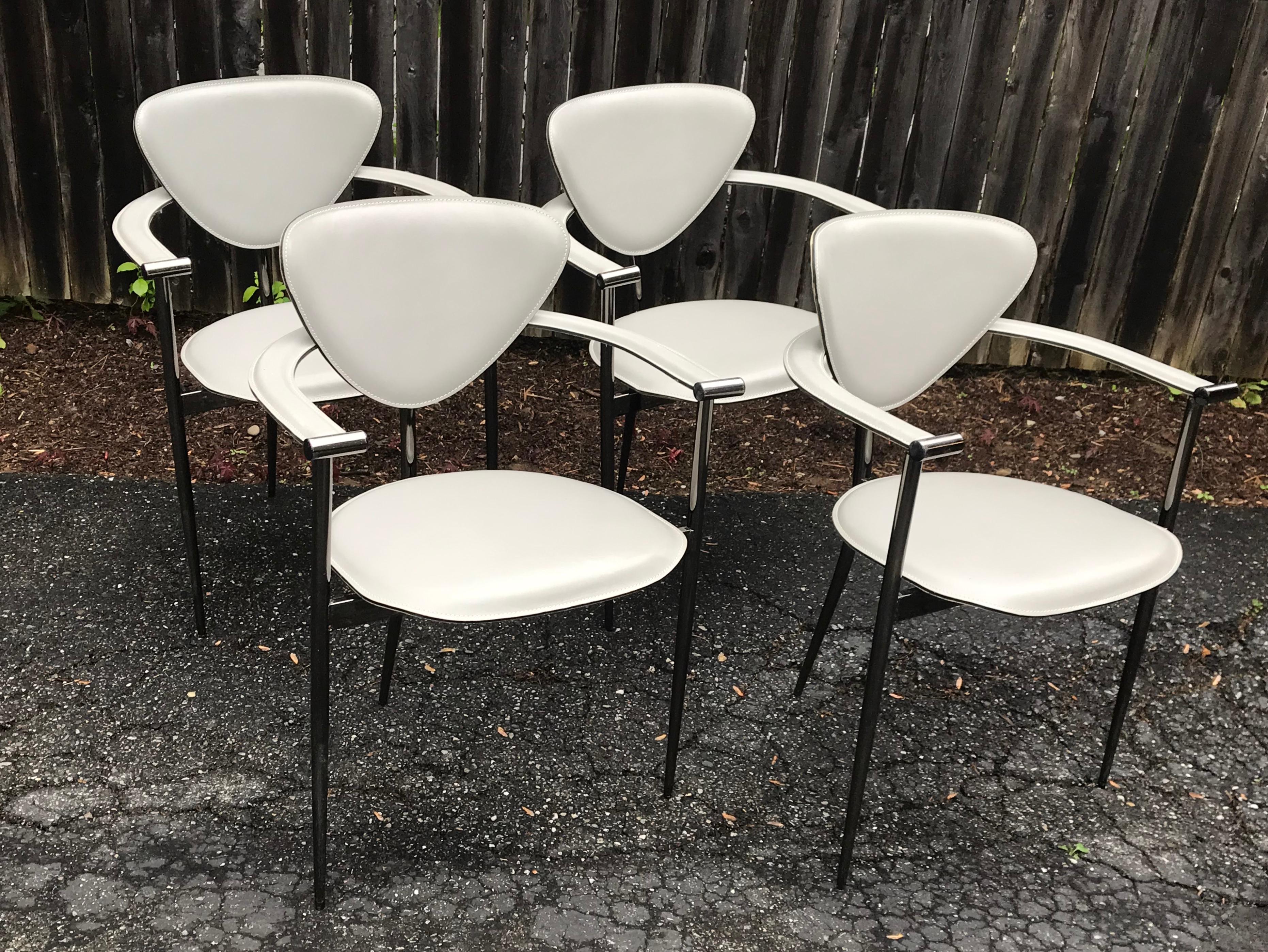 Beautiful set of four dining chairs by Arrben Italy, circa 1980s. Light gray leather seat, armrest and backrest mounted on stiletto leg smoked chrome frames. Overall good condition with minor scuffs to leather and frames, minor separation of leather