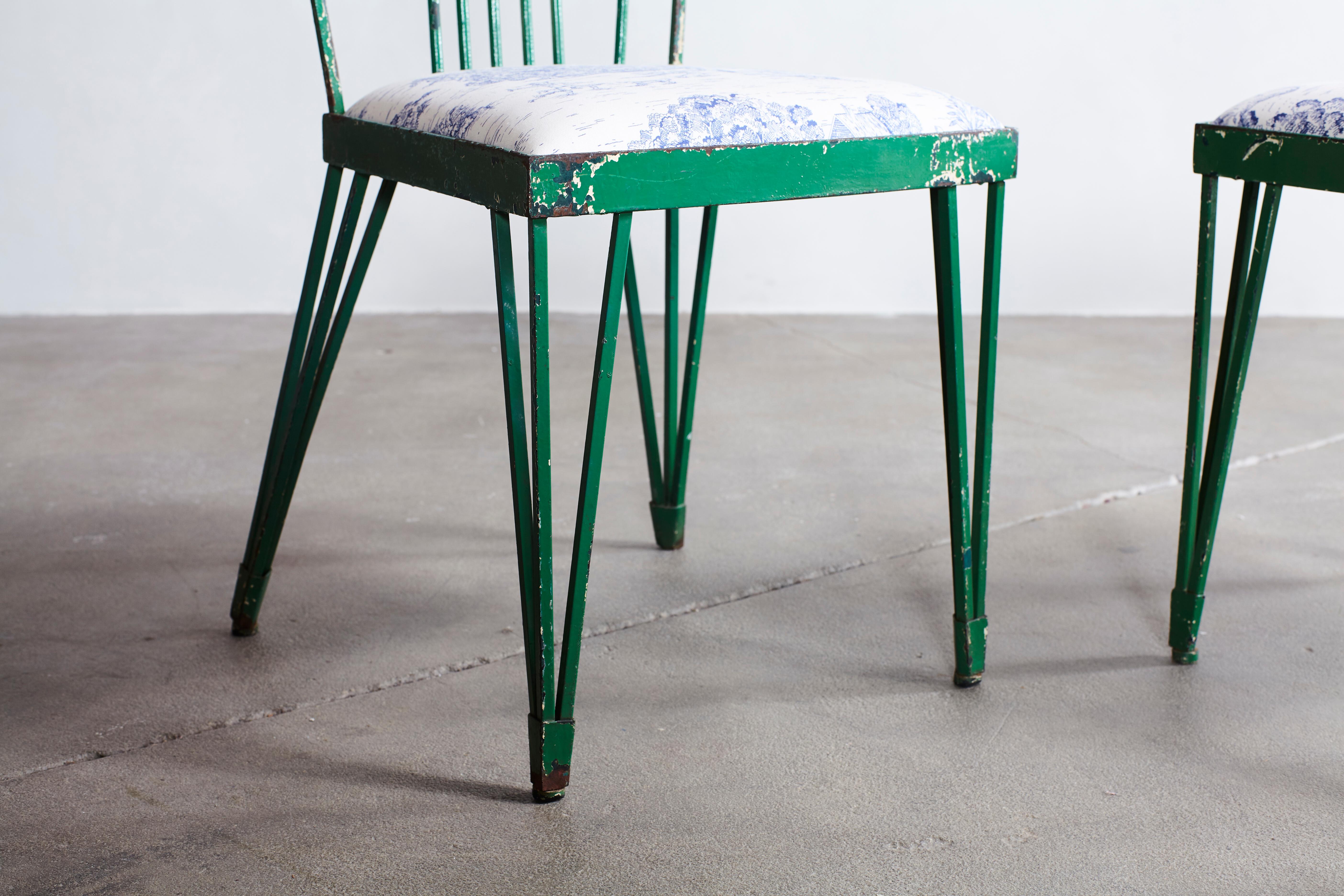 Set of four green metal modernist chairs newly upholstered in blue and white toile fabric.