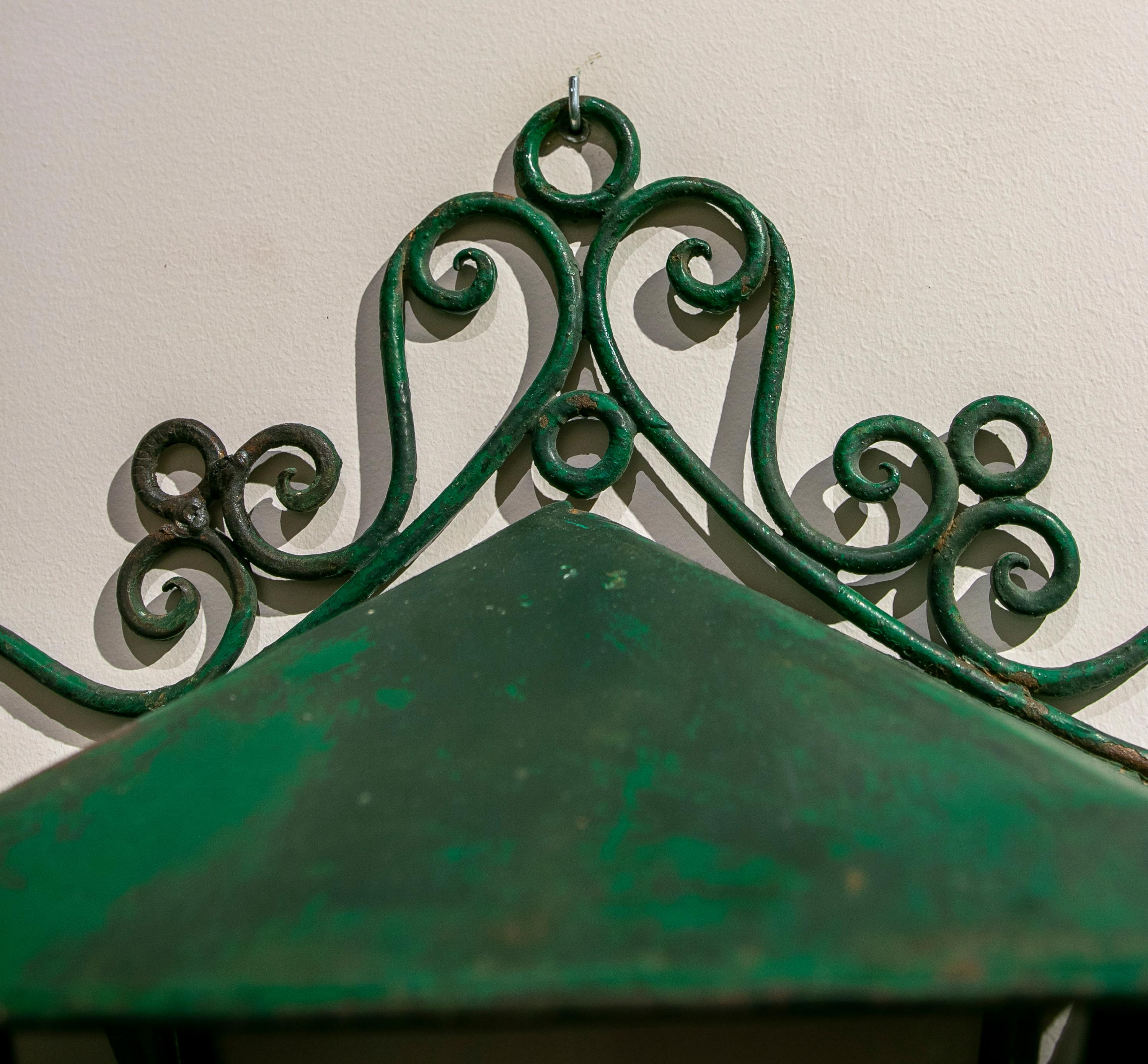 Set of four green painted iron wall lanterns.