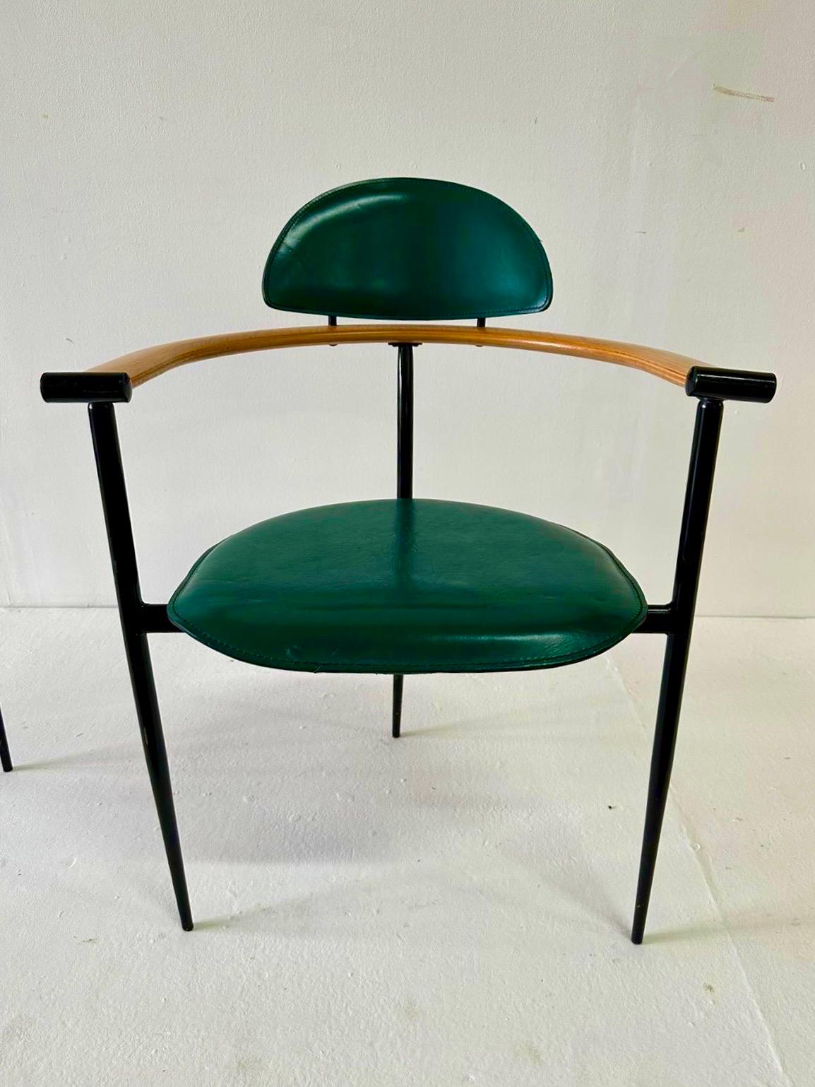 These Italian stitched green leather chairs with natural wood armrests and steel frame by ARRBEN ITALIA.  Four chairs are all vintage and simply stunning.  Green is vivid in light - see all pics and video.  Comfortable and perfect for small dining