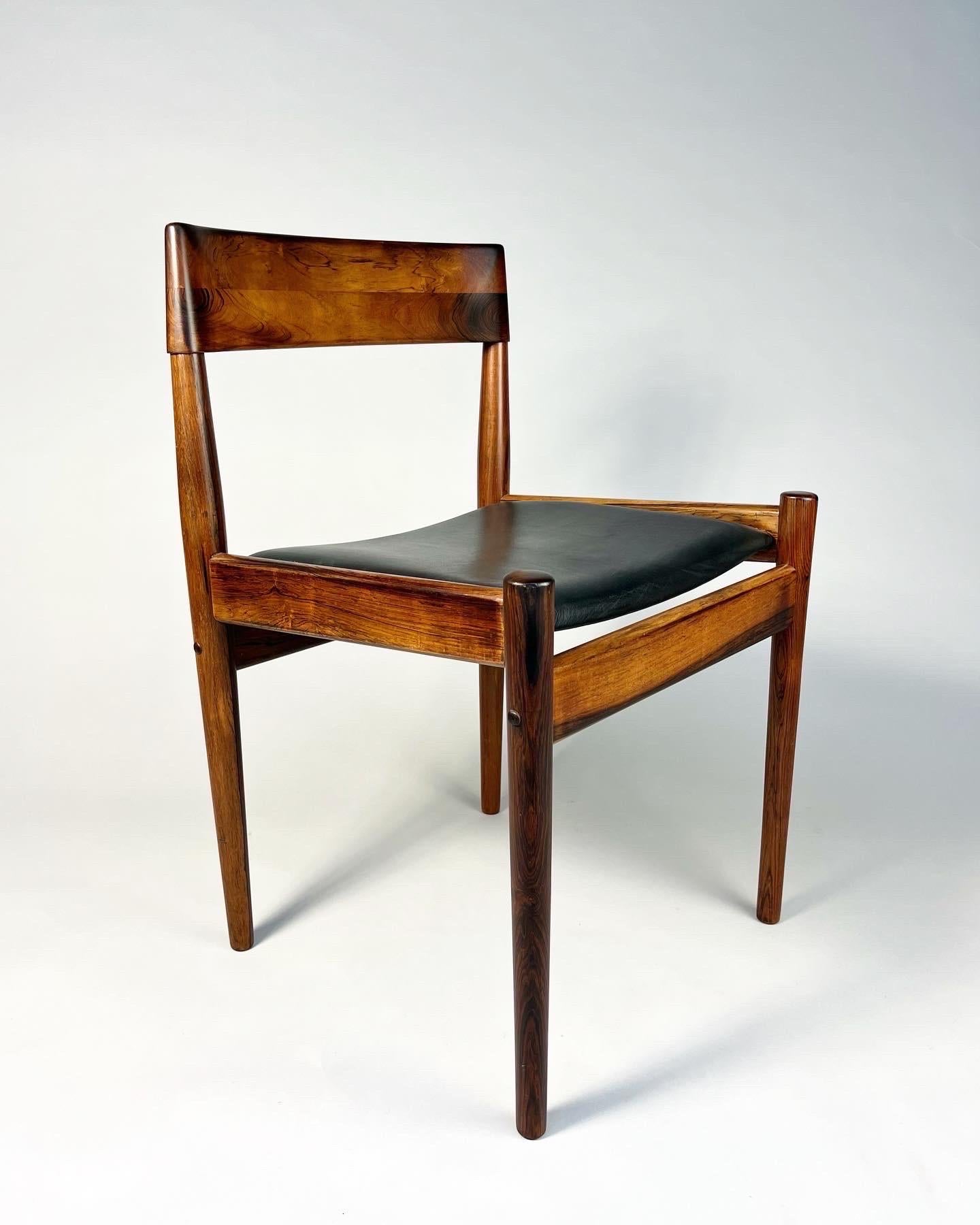 Set of four dining chairs, designed by Grete Jalk for P. Jeppesen, model No. PJ4-2, made in Denmark in the early 1960s.

Solid rosewood frame with a beautiful grain, refinished with laquer. Upholstered in black leather.



