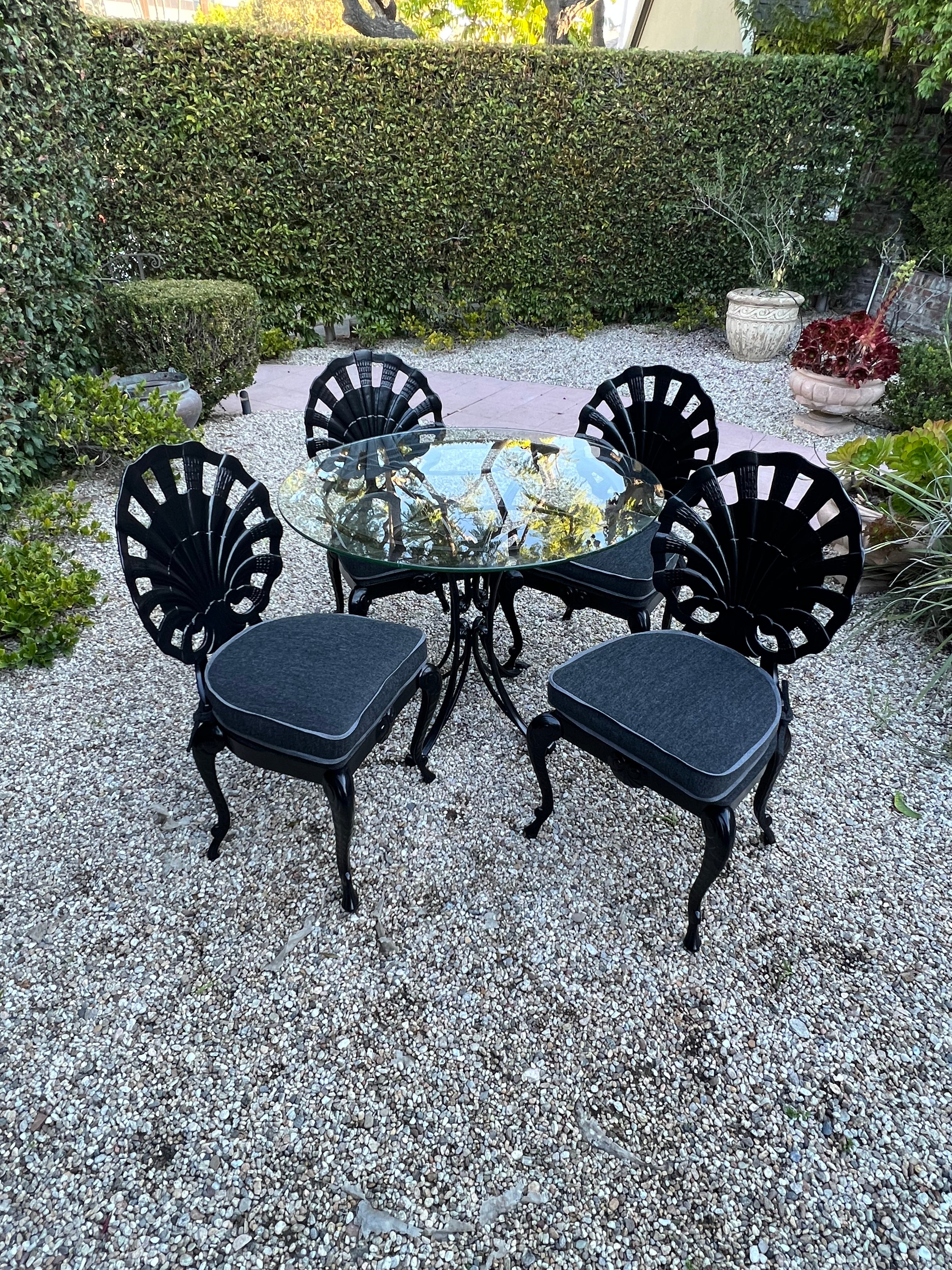 A set of four Grotto chairs newly upholstered and powder coated. The set are a compliment to any dining area, inside or out of doors. The powder coating allows them to be outside as does the outdoor sunbrella fabric. A wonderful set of four chairs