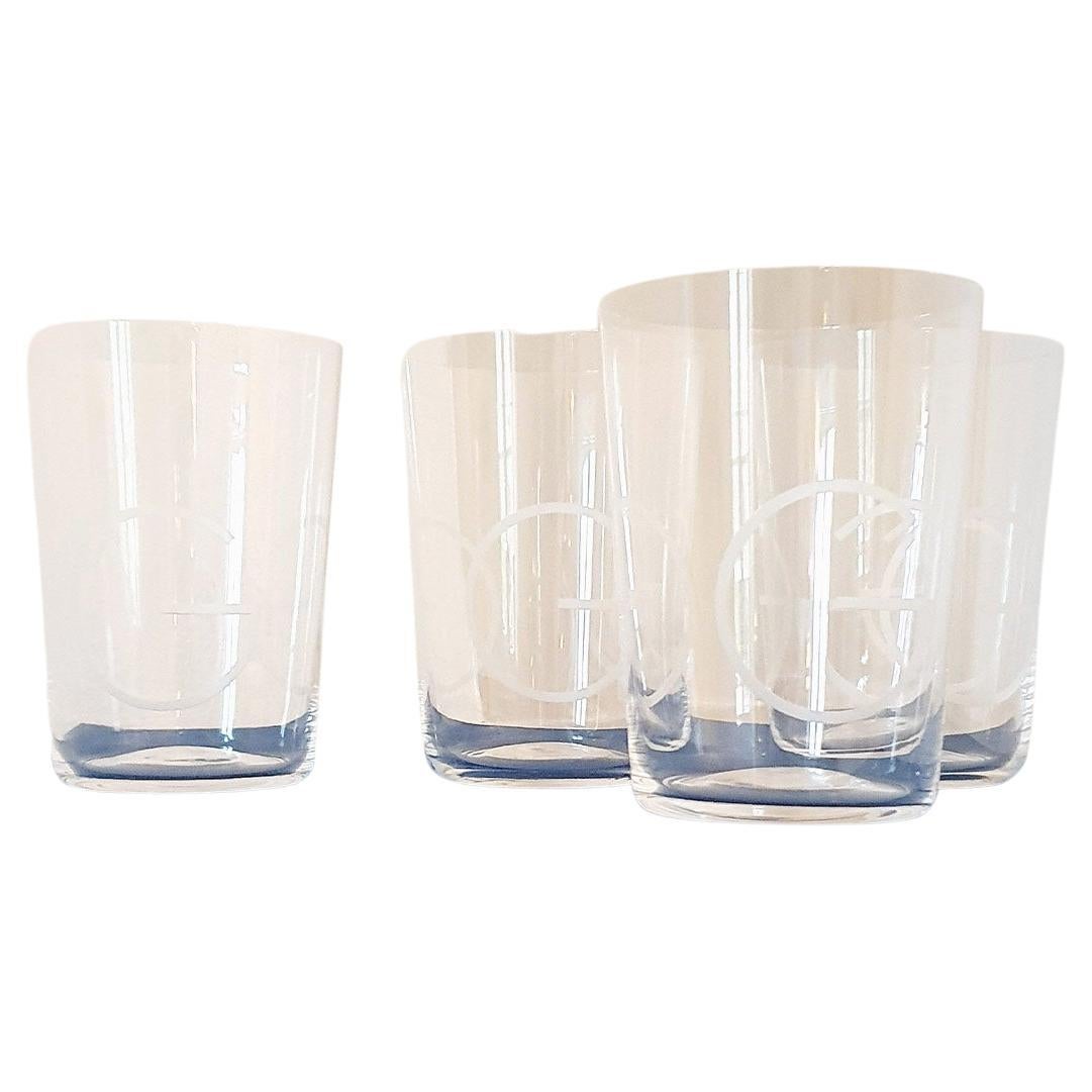 A set of four large Gucci Glasses etched with three giant decorative Gucci 'Gs'. The glasses are hand-blown and made in very fine glass. They were made in the 1980s and found in a private home in Florence. Each glass is etched Gucci Made in Italy on