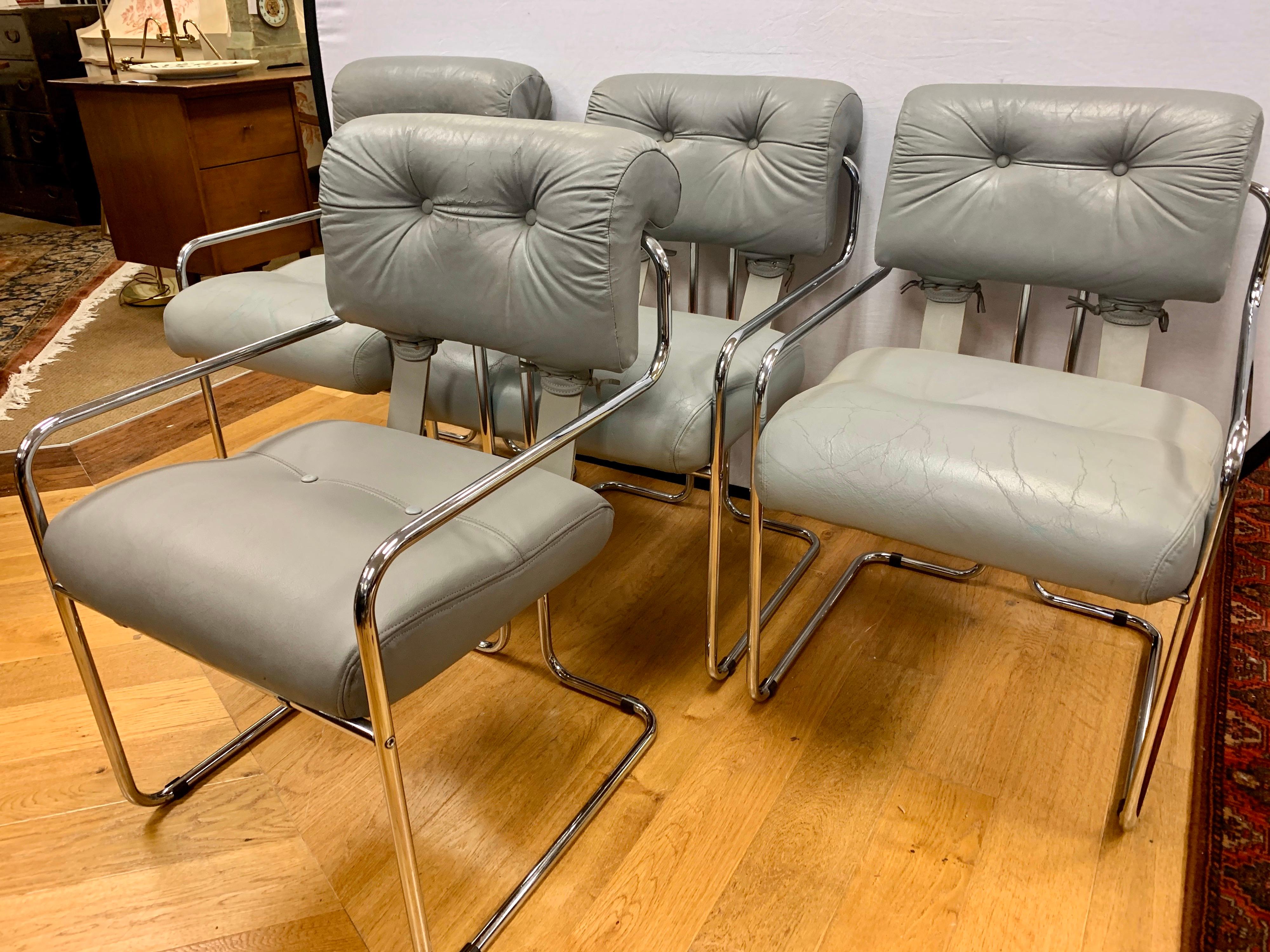 Rare chome and leather dining chairs by Guido Faleschini for Pace collection and manufactured by i4 Mariani in Italy. All vendor hallmarks are present at bottom, circa 1980s. Note the soft gray leather has wear on each chair and this has been