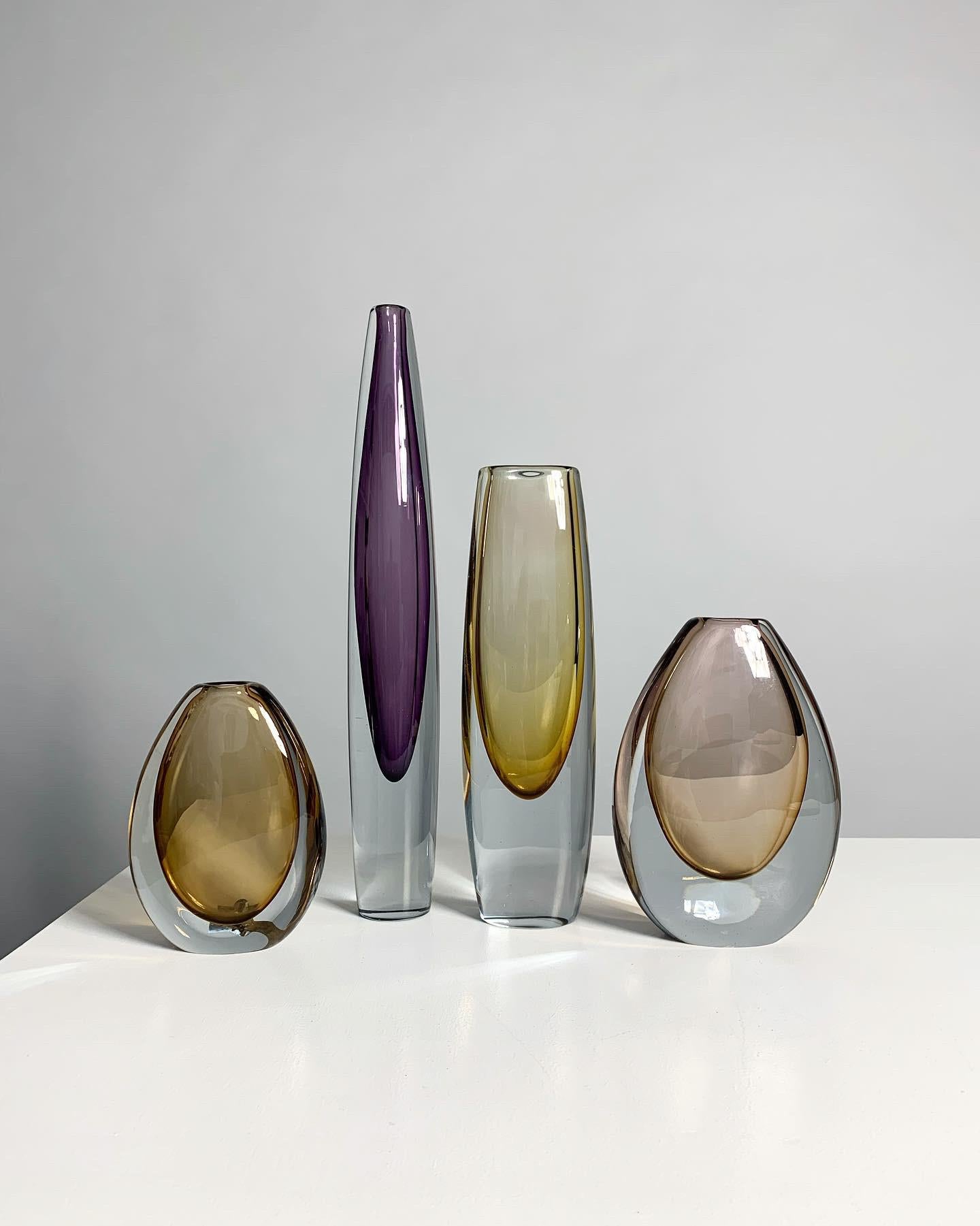 Set of four Gunnar Nylund & Asta Strömberg vases in colored and clear crystal for Strömbergshyttan, Sweden 1960s.

This listing contains the set of four shown in first photo, left to right

• Amber colored, Gunnar Nylund, h: 14.5 cm, signed

•