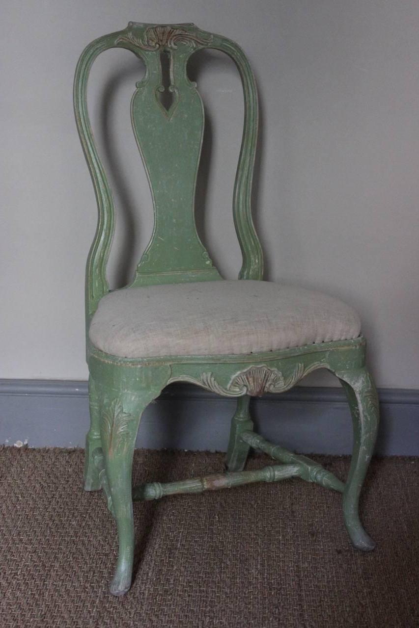 A very charming and decorative set of four, early to mid-20th century Swedish painted chairs, with a lovely pale green color and drop-in calico seats, in the Gustavian taste.
 