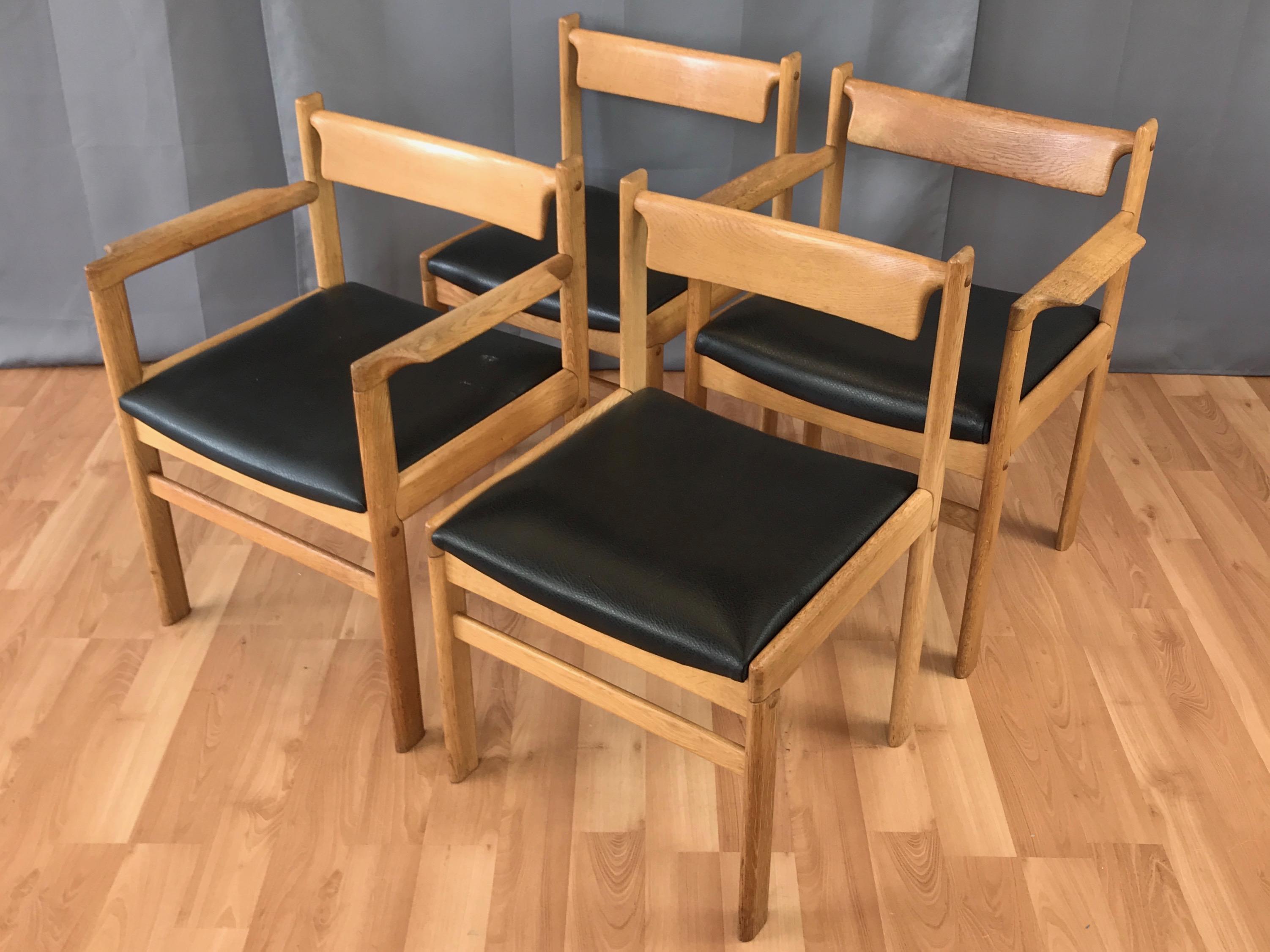 A set of four late 1960s oak dining chairs by Hagen International of San Francisco, California.

Solid blonde oak frame with black faux leather seat exhibits a well-crafted and appealingly unpretentious melding of American and Scandinavian