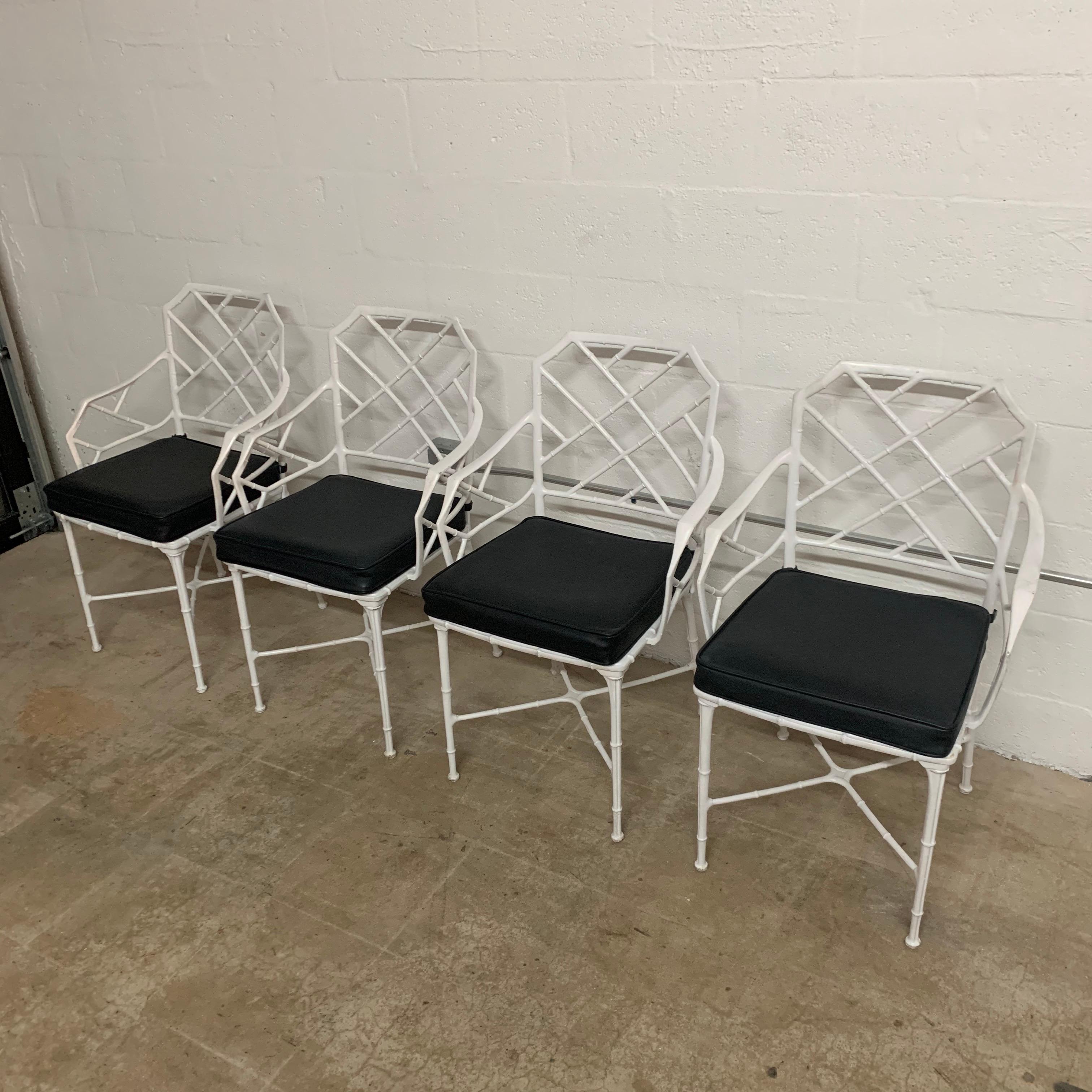 Classic set of Chinese Chippendale faux bamboo dining chairs for outdoor, garden, or patio with arms rendered in original white powder coated cast aluminum with black marine grade vinyl cushions. Designed by Hall Bradley for Brown Jordan, 1967.