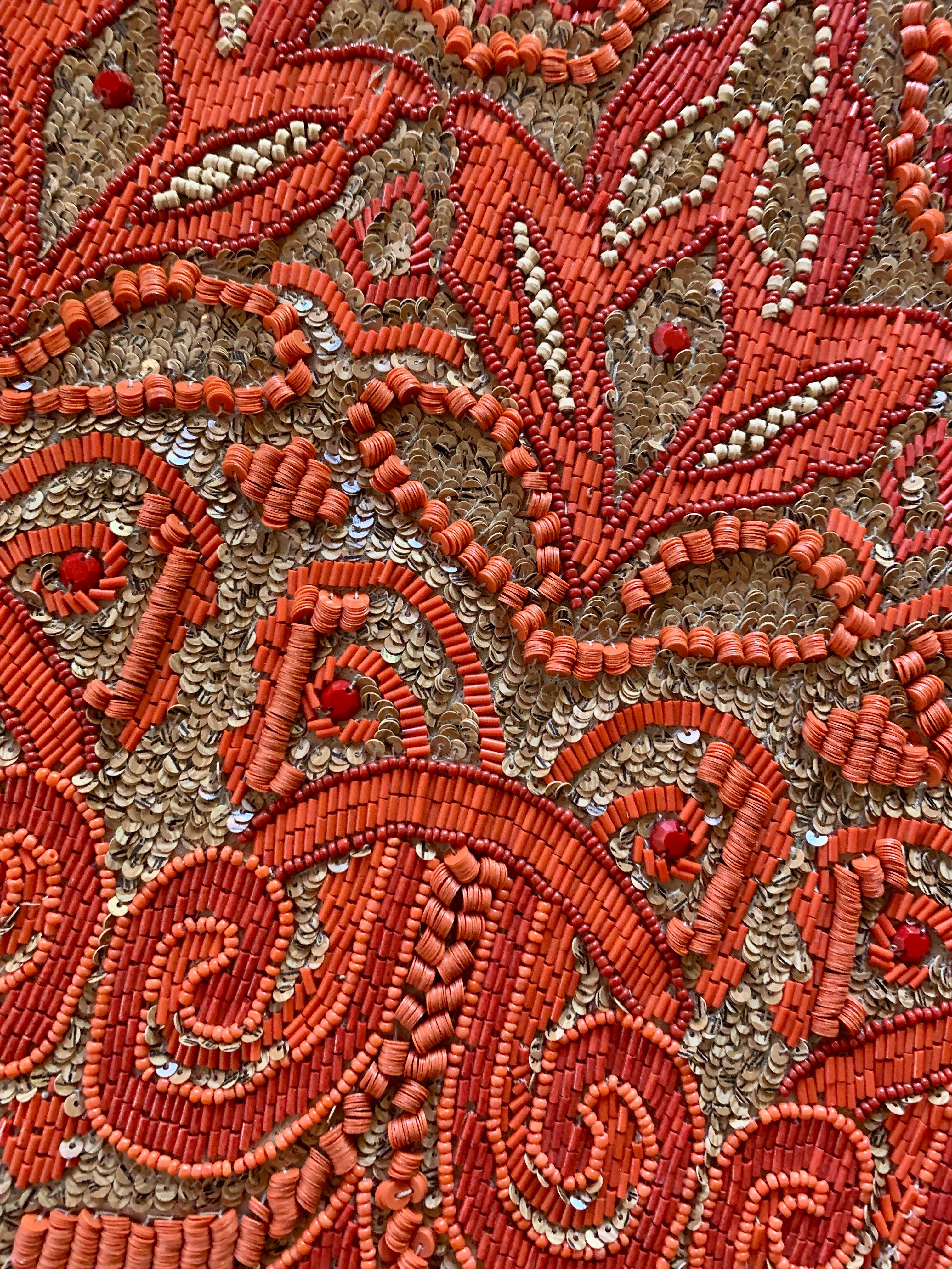 Set of four hand beaded placemats. The unique designed placemats are hand beaded with glass, wood and plastic beads - the shape is a departure from the standard oval or rectangular. Brilliant orange beads on a woven raffia field makes for the