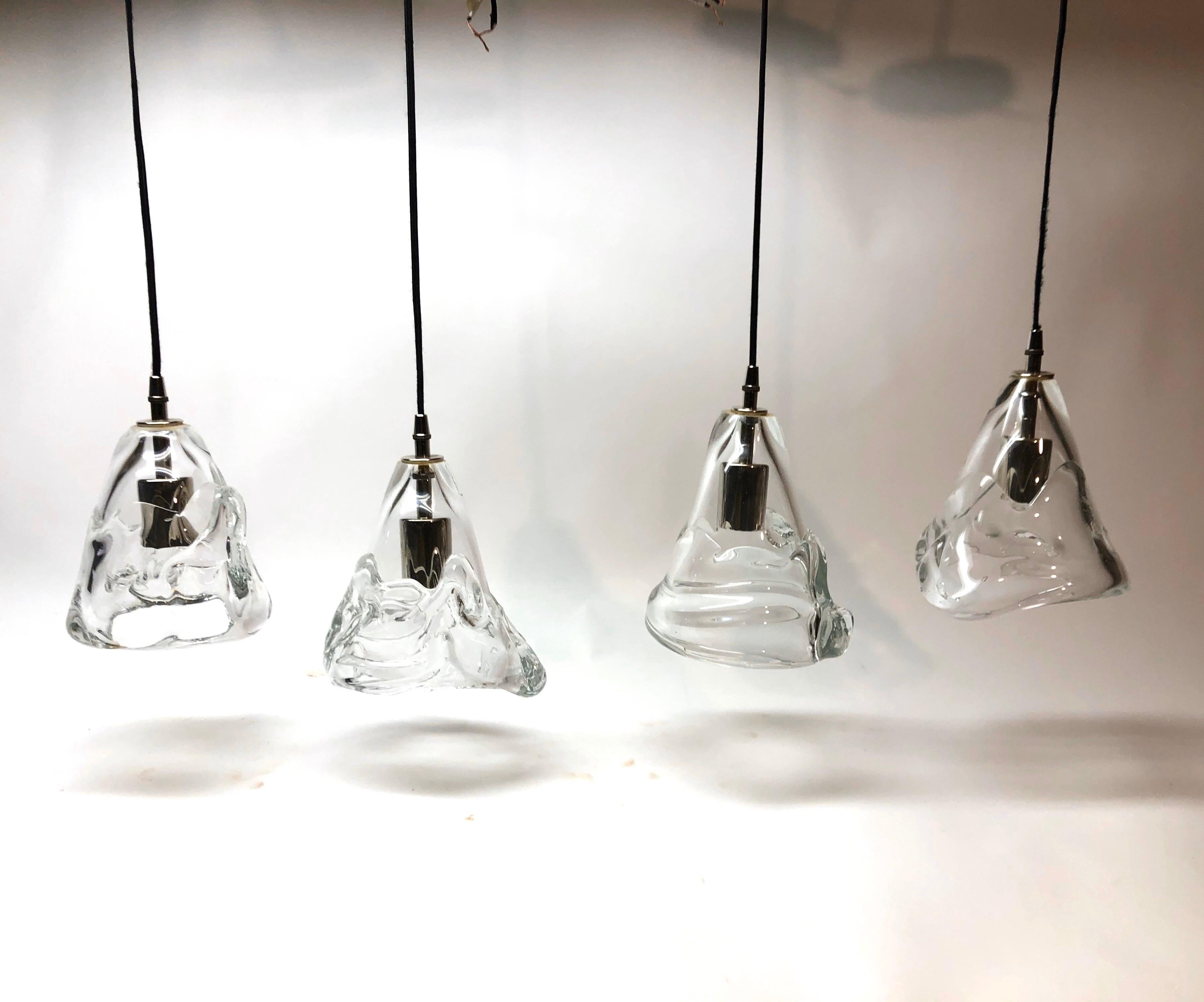 Four hand blown clear glass light pendants signed illegibly...
Measurements each glass bell varies slightly... all have been newly rewired with black silk covered cord... Length of the cord on its own is 50