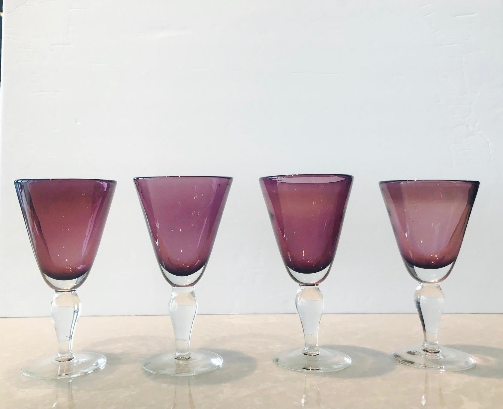 Set of four vintage wine or water goblets in blown Murano glass. Glasses have clear glass stems with gorgeous amethyst colored cased glass goblets. Each varies slightly as they are unique and individually hand blown.