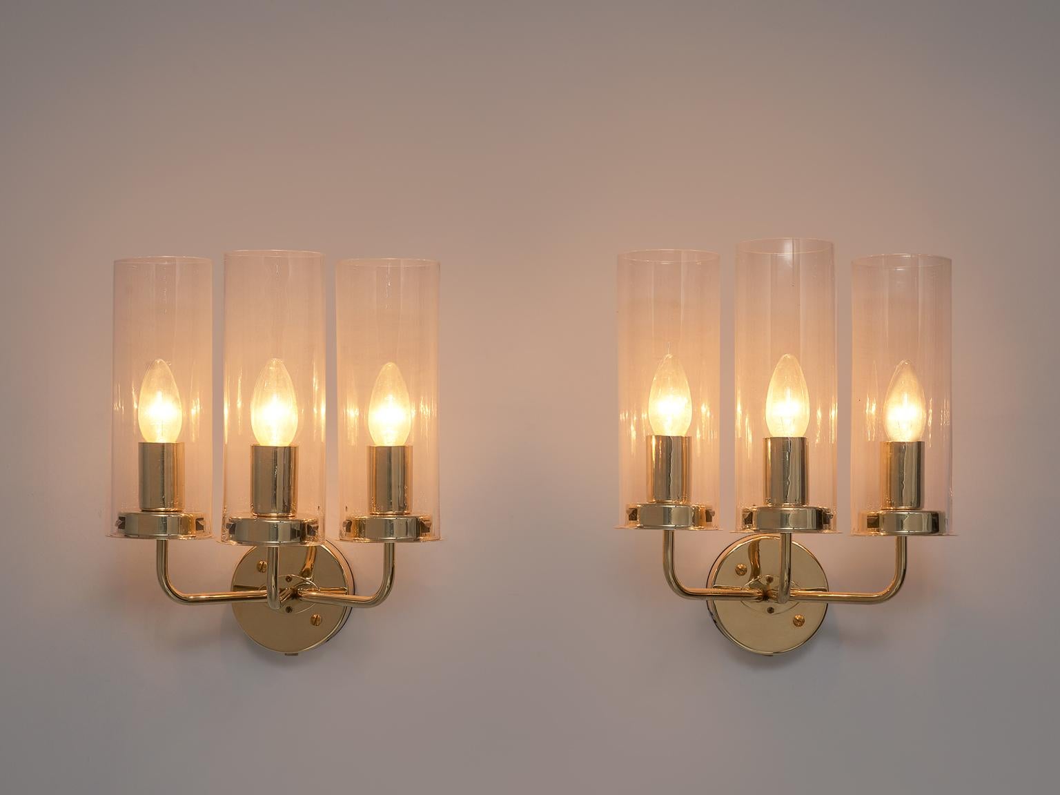 Hans Agne Jakobsson, set of 4 'Sonata' Wall lights, brass and glass, Sweden, 1960s

Elegant wall lights designed by Swedish Master of Light; Hans Agne Jakobsson. This Classic lamp features a round fixture with 3 arms that each hold bulb with a glass