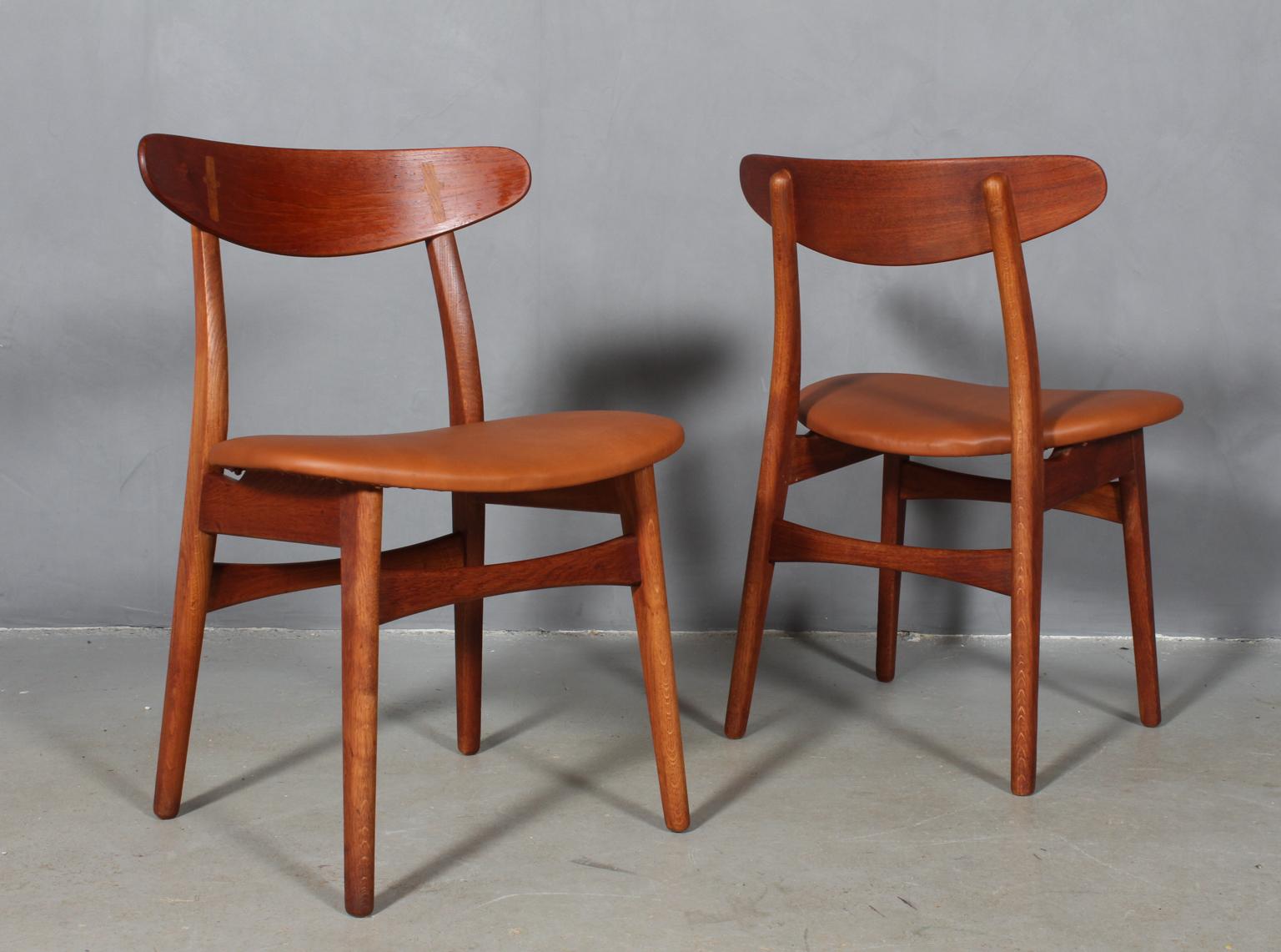 Set of four Hans J. Wegner dining chairs in teak and oak.

New upholstered with walnut elegance aniline leather.

Made by Carl Hansen. 

The CH-30 was originally designed in 1952 and was one of Wegner’s first chairs. The design has become a