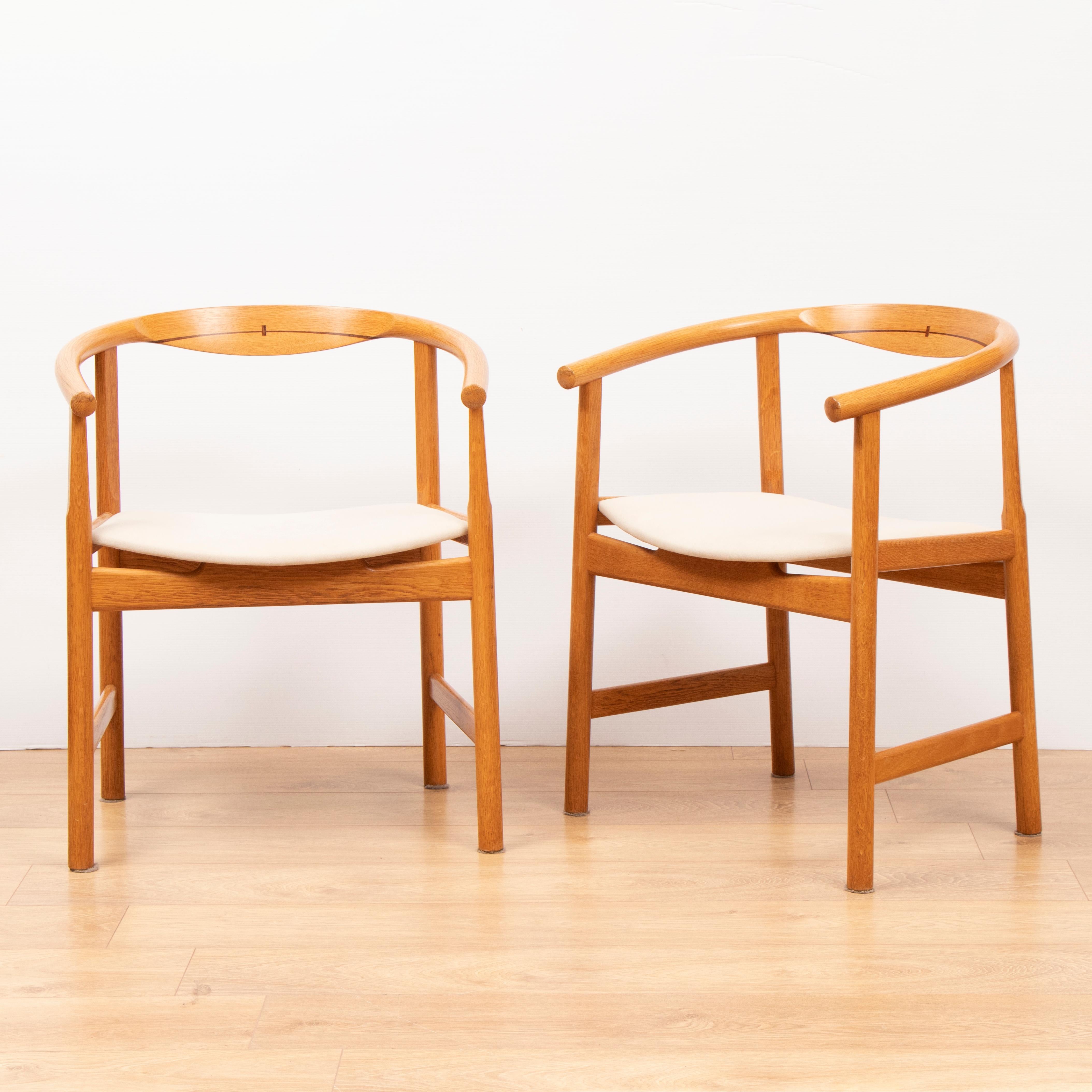 Set of Four Hans J. Wegner JH 203 Oak with Wenge detailing armchairs. Designed by Hans J. Wegner in 1969 for Johannes Hansen in 1969 in Denmark. The chair is made from Oak with inlaid Wenge detailing, The seats have been recovered in Romo Group's