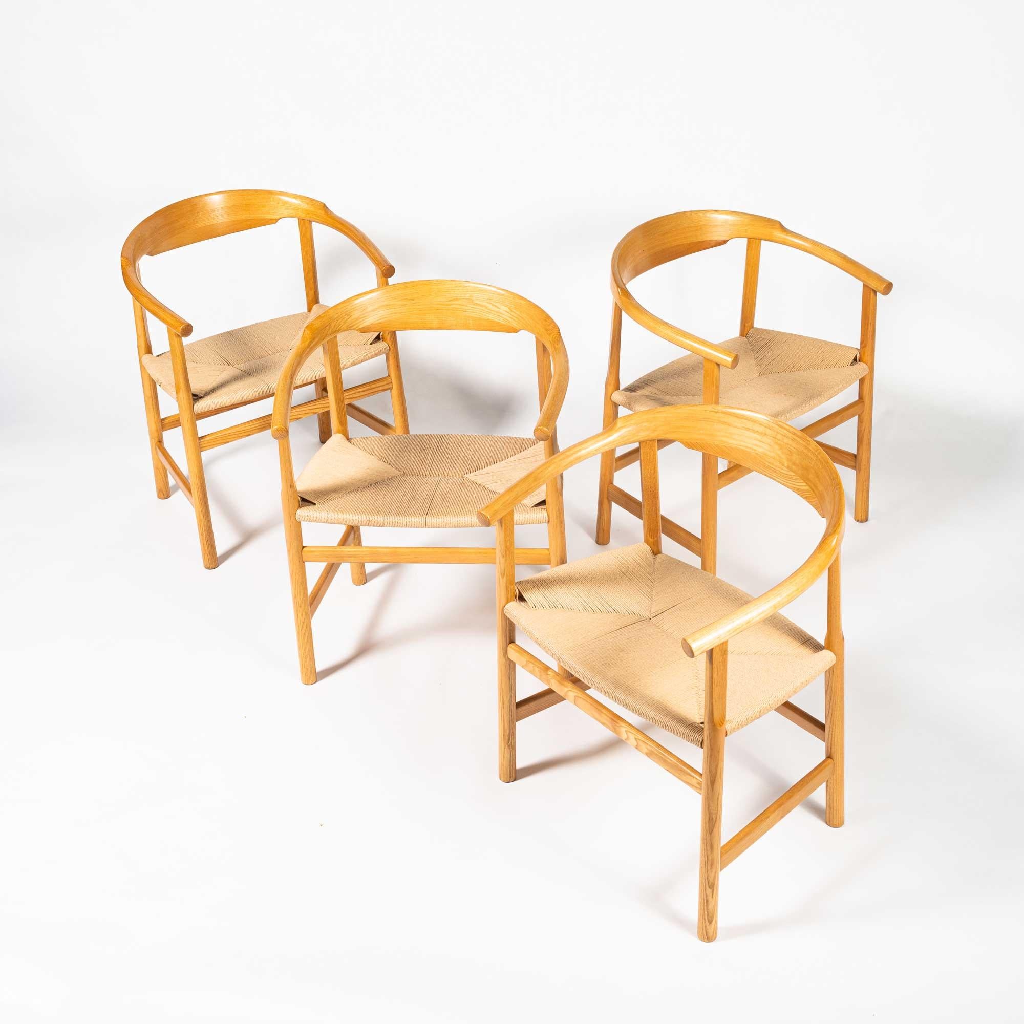 A rare set of four PP209 Hans Wegner arm chairs in oiled oak and paper-cord, produced by PP Møbler (for DSB ferries), between 1974 and 2004. Unlike the Round chair, the backrest for this model was cut from a single piece of wood and bent into shape.