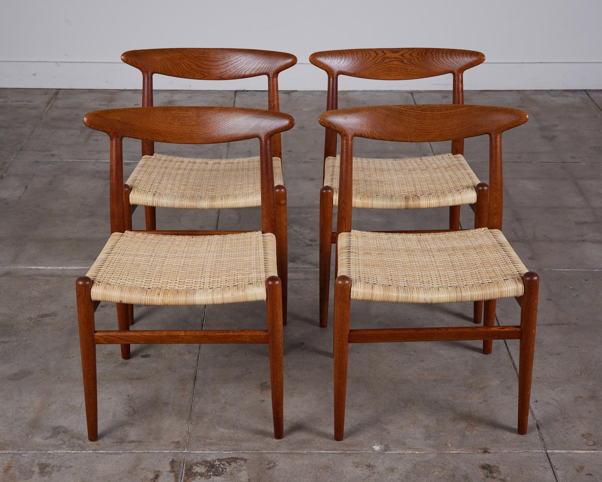 Set of four Hans J. Wegner dining chairs in oak and cane, c.1950s, Denmark. The model W2 were executed by C.M Madsen.

Stamped C.M. Madsen FABRIKER- MADE IN DENMARK.

Dimensions: 22