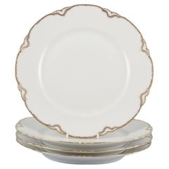 Set of four Haviland porcelain dinner plates with gold decoration, 1930s/40s
