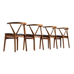 Set of Four Henning Kjaernulf Dining Chairs in Teak and Black Upholstery