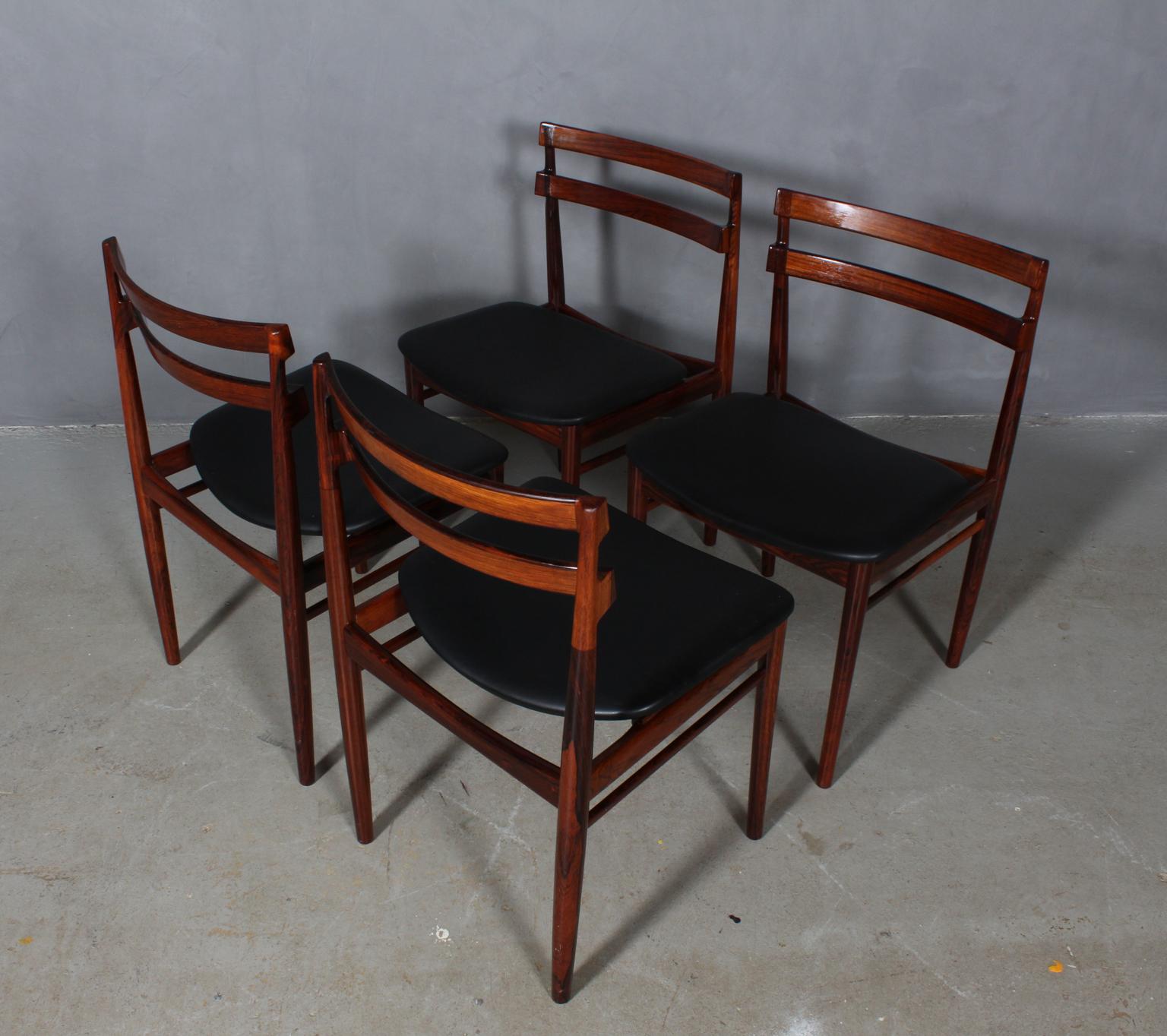 Set of six Henry Rosengren Hansen dining chairs, frame of partly solid rosewood with great details.

Seat new upholstered with black pure aniline leather.

Made by Brande Møbelindustri.