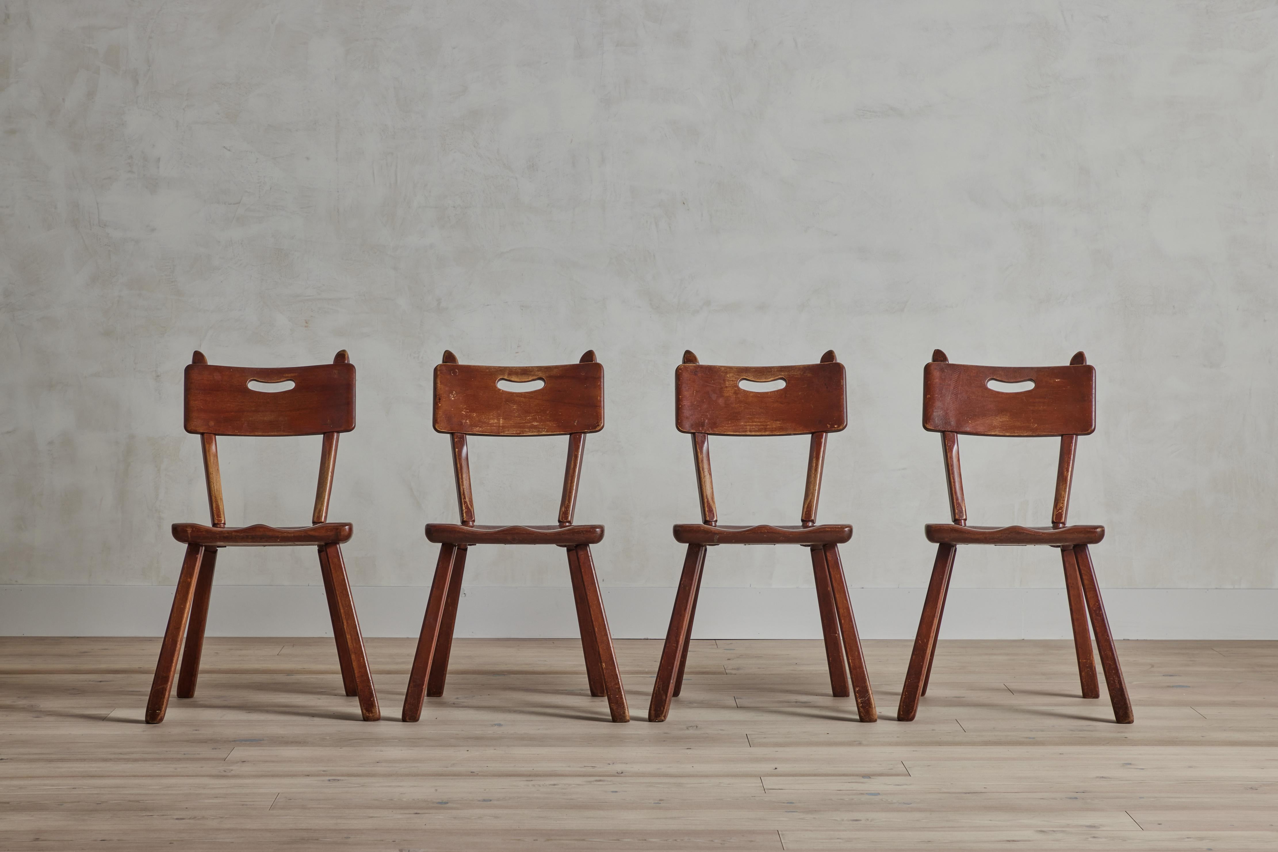 Set of four Cushman Colonial Creations maple wood dining chairs by Herman De Vries. Some visible wear on original finish. Chairs have been cleaned and waxed. United States, circa 1940.