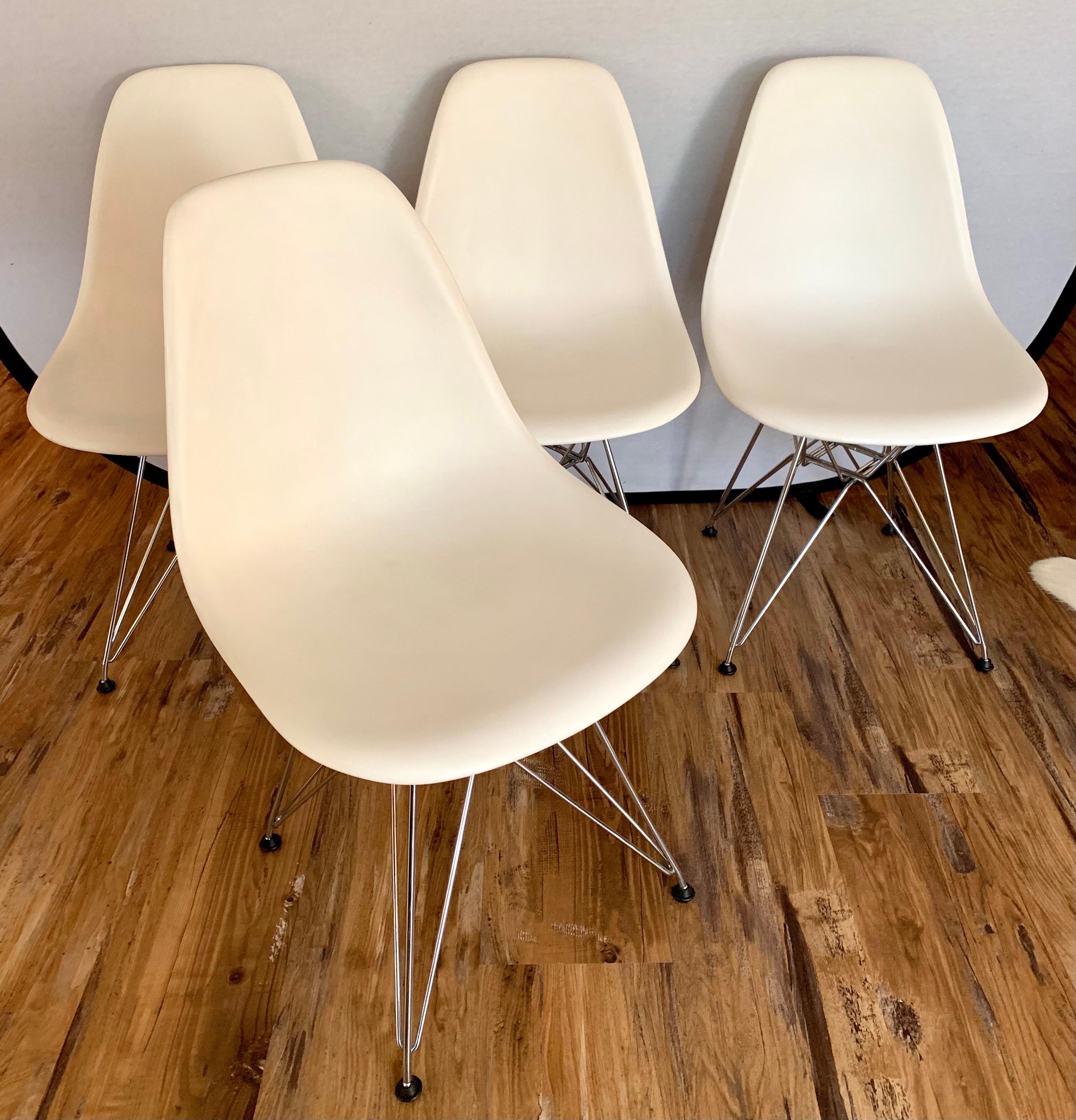 Iconic set of plastic Eames Office chairs which make great dining chairs as well. Designed by Charles and Ray Eames for Herman Miller. All hallmarks at bottom. Great scale and better lines. Colorway is white.