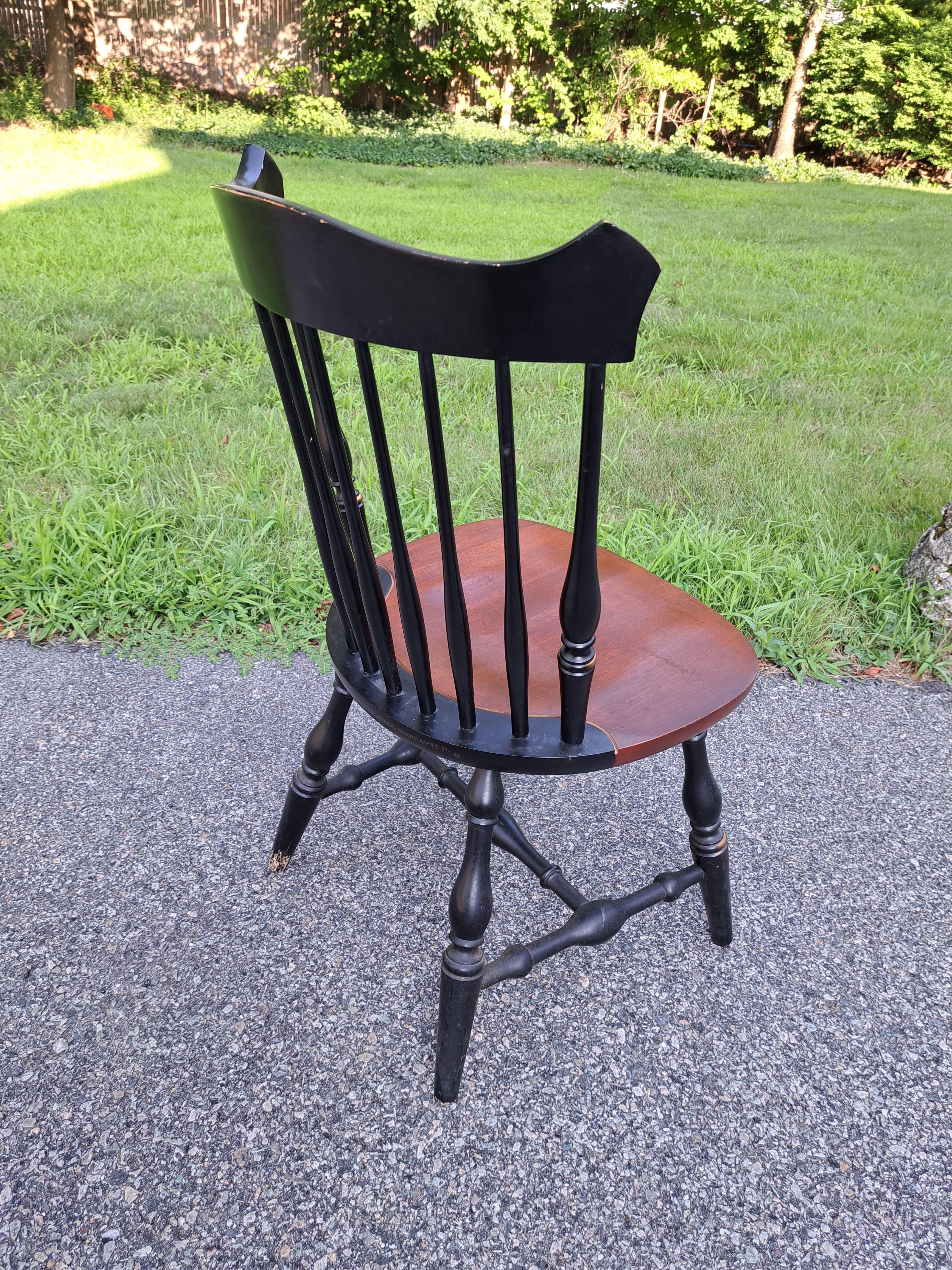 Set of four solid maple Hitchcock Furniture Co. Windsor style dining chairs including two captains chairs with arms and two without arms. Beautiful set with the maker's name stenciled in gold on the back of each seat.