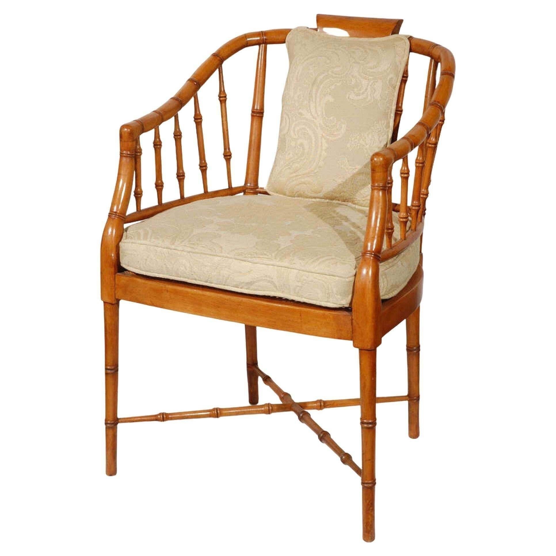 An elegant set of four vintage faux bamboo armchairs. Upholstered in a creamy fabric with a raised floral design.