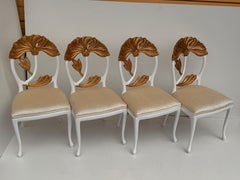 Set of Four Hollywood Regency Chairs with Carved Lotus Leaves in Goldleaf