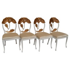 Set of Four Hollywood Regency Chairs with Carved Lotus Leaves in Goldleaf
